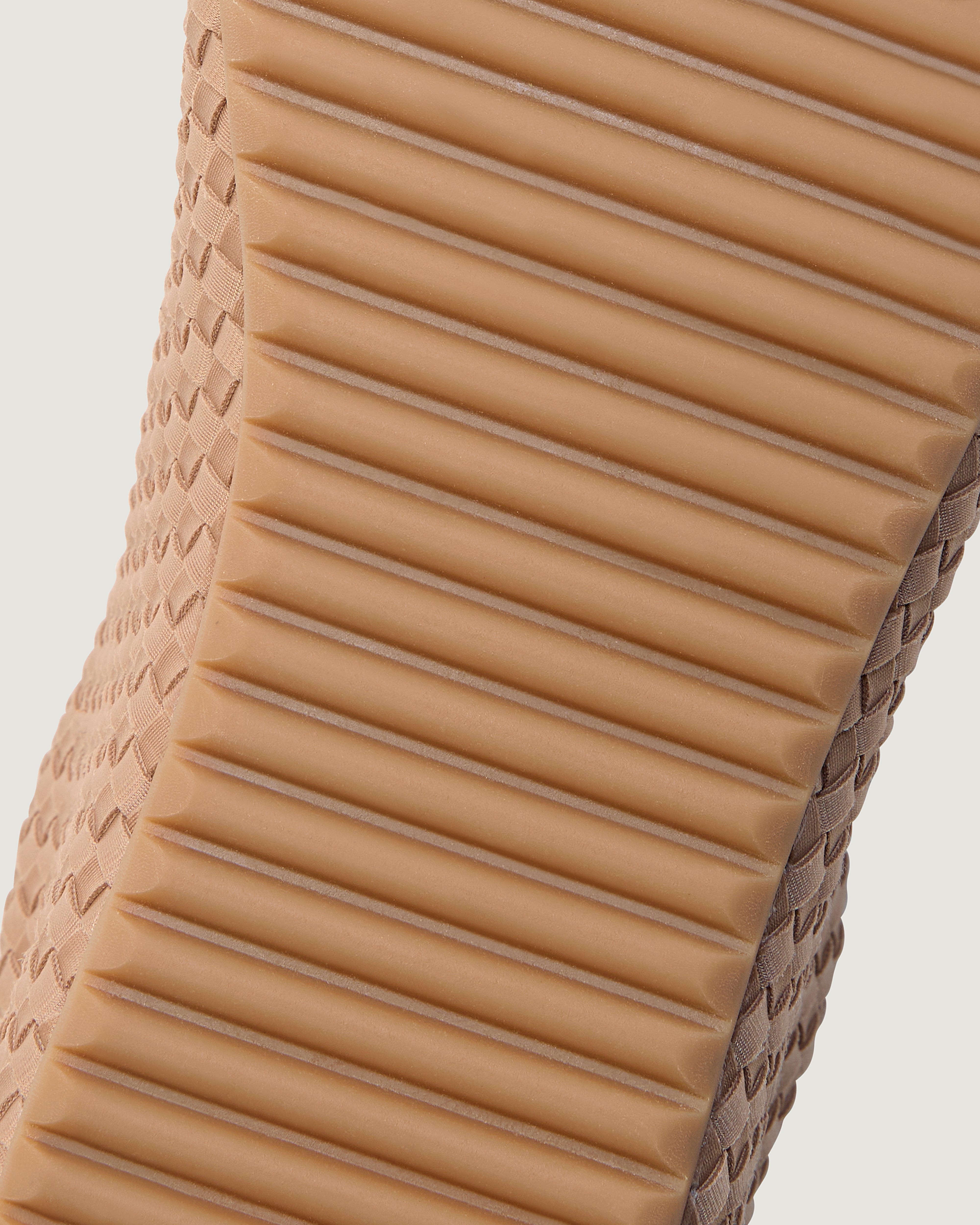 Bottom view of The Milan Sneaker in Seychelles showing the natural tanned rubber sole.