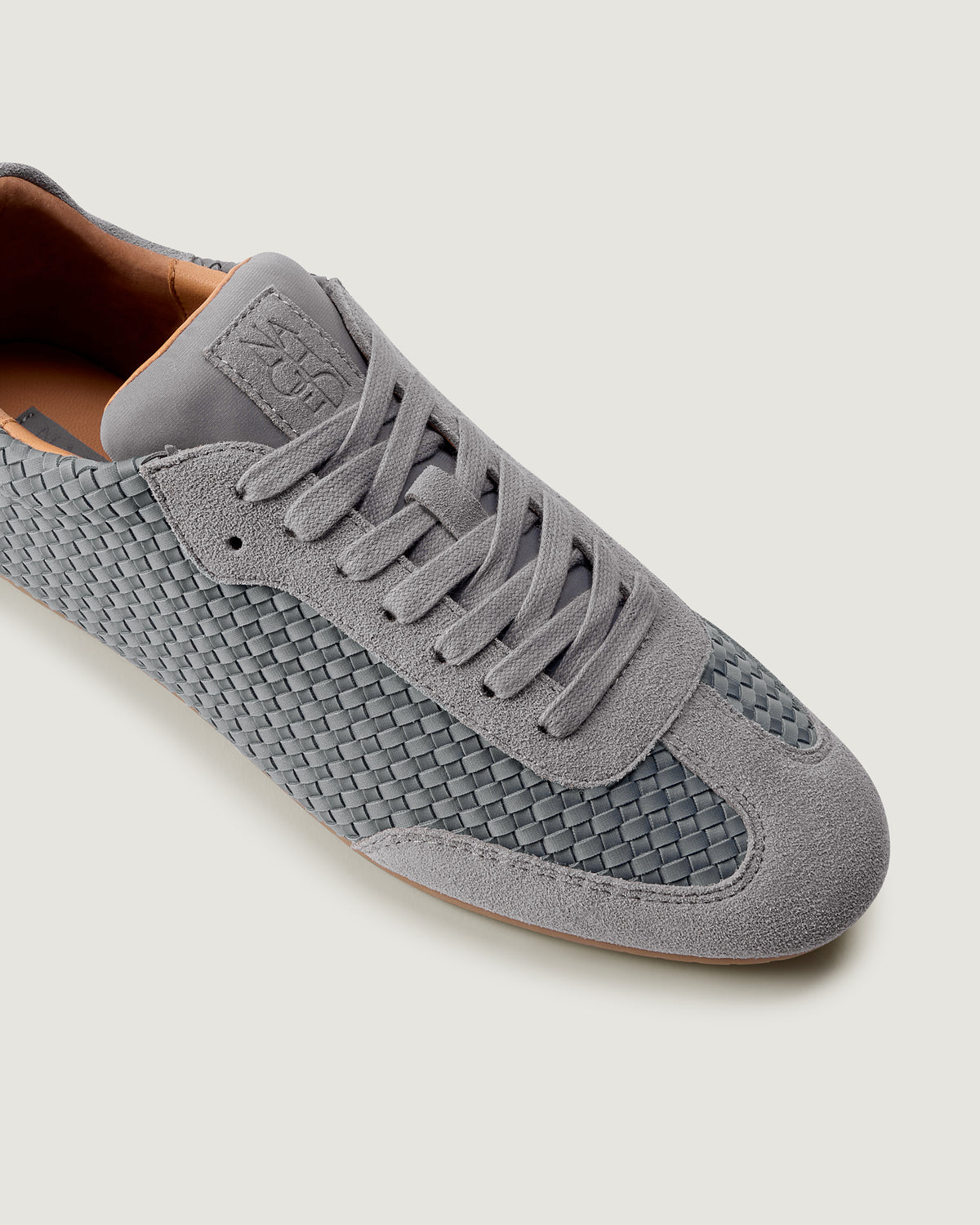 Close-up of The Milan Sneaker in Slate Blue showing its tonal suede trim.