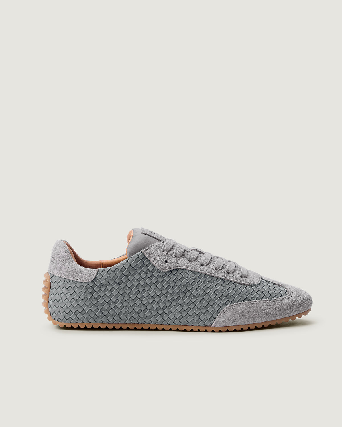 Side view of The Milan Sneaker in Slate Blue, a blue grey, featuring a closed toe and almond silhouette.