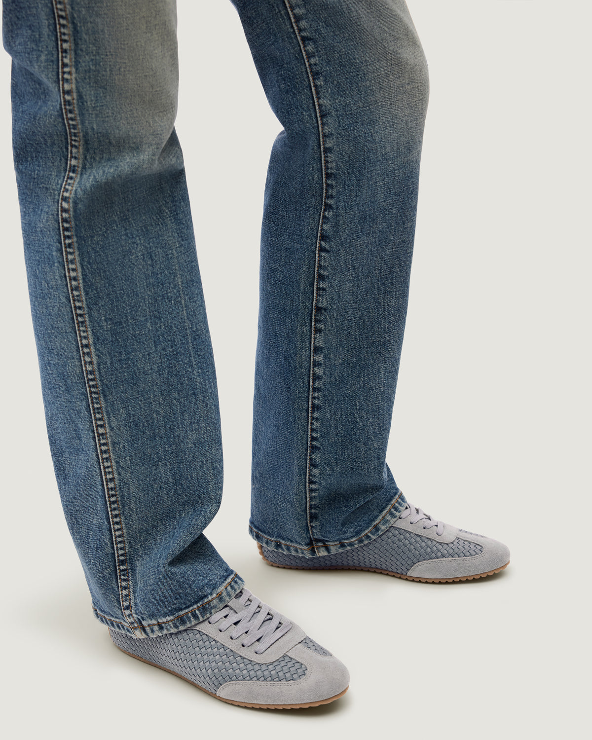 The Milan Sneaker in Slate Blue shown on model.
