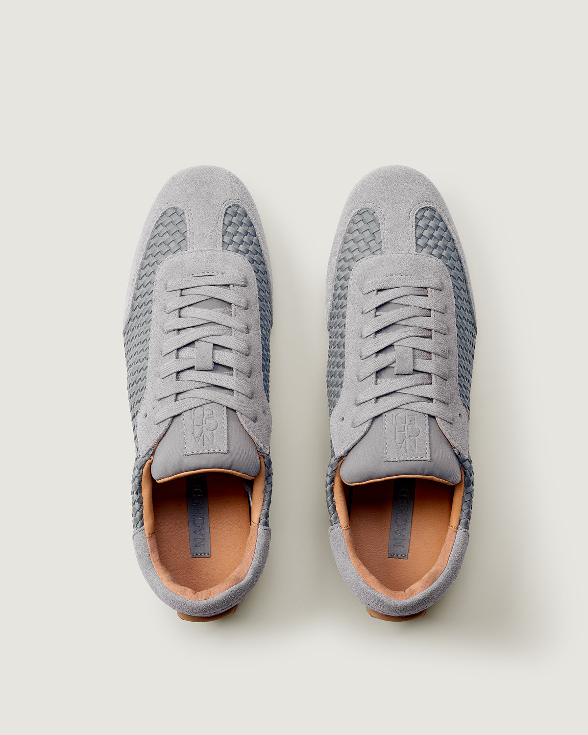 Top view of pair of The Milan Sneaker in Slate Blue showing the natural tanned leather insole.