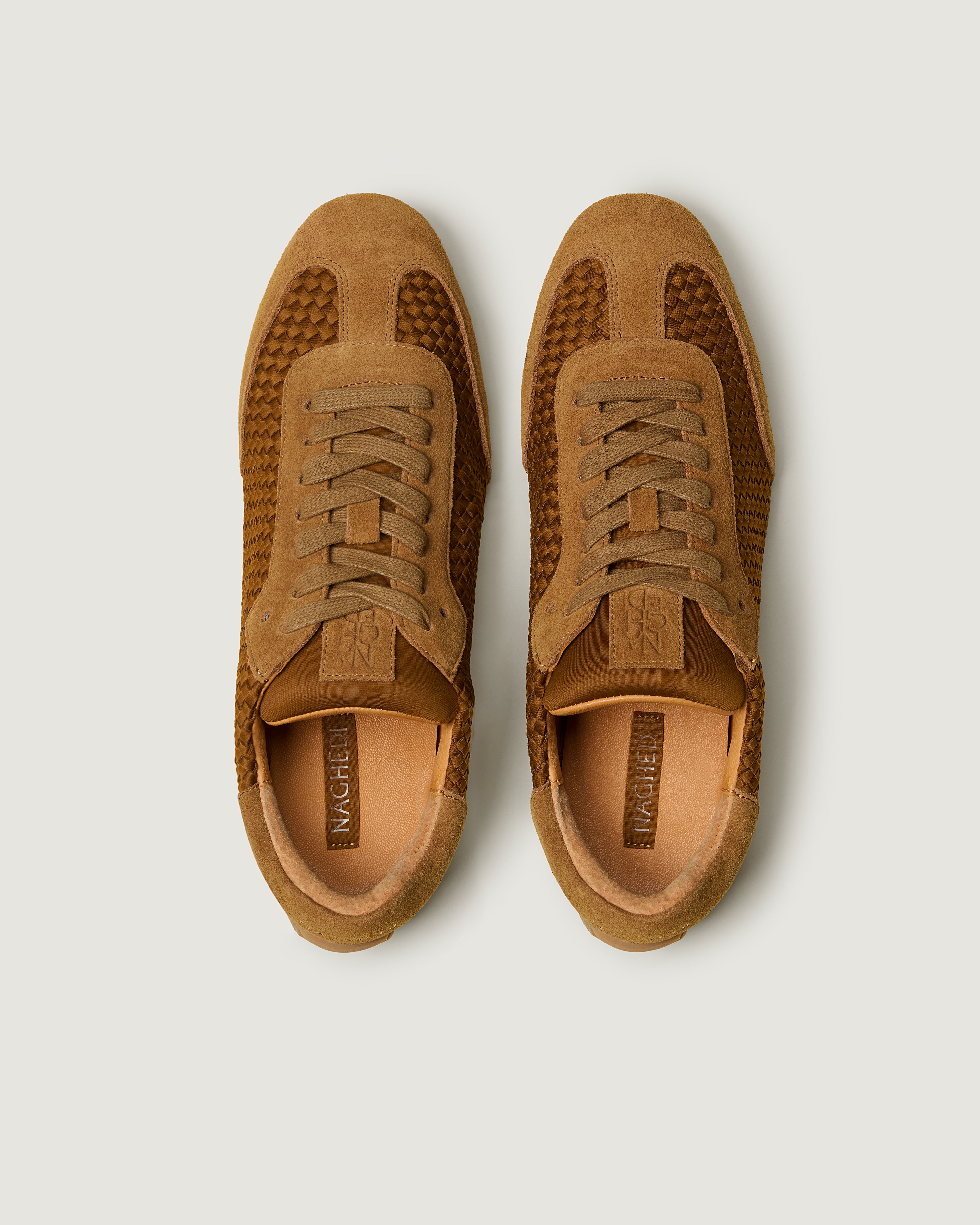 Top view of pair of The Milan Sneaker in Teak showing the natural tanned leather insole.