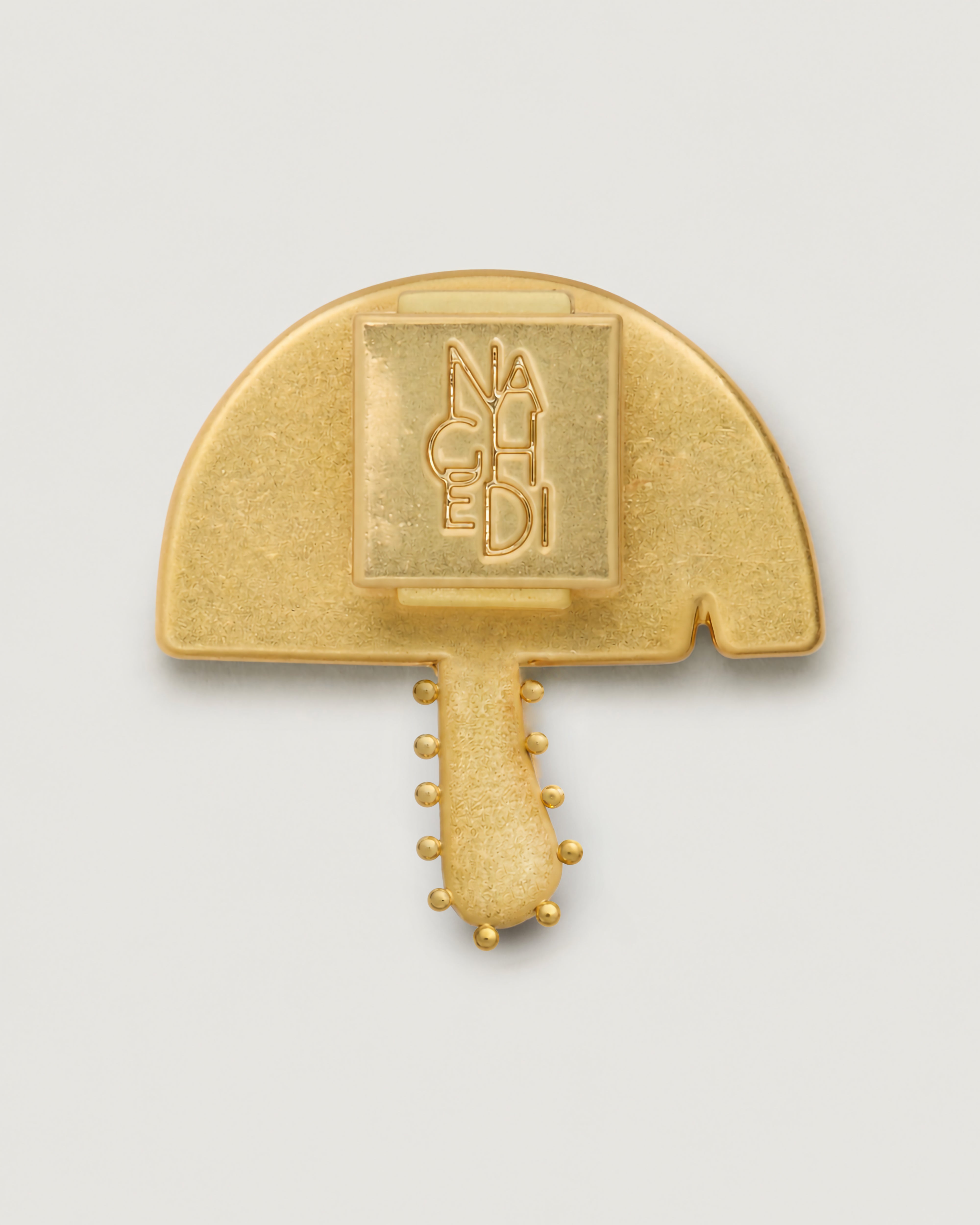 Close up of the Magic Mushroom Bag Charm highlighting the pin backing.