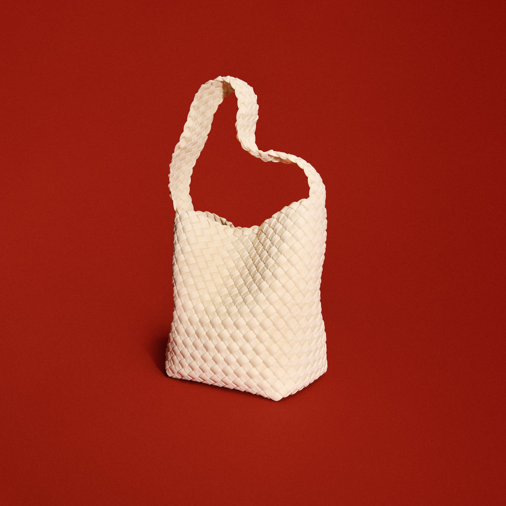 Nomad Hobo in Salt in handwoven neoprene, featuring an open top with magnetic snap closure, and handwoven shoulder strap lays comfortably flat.