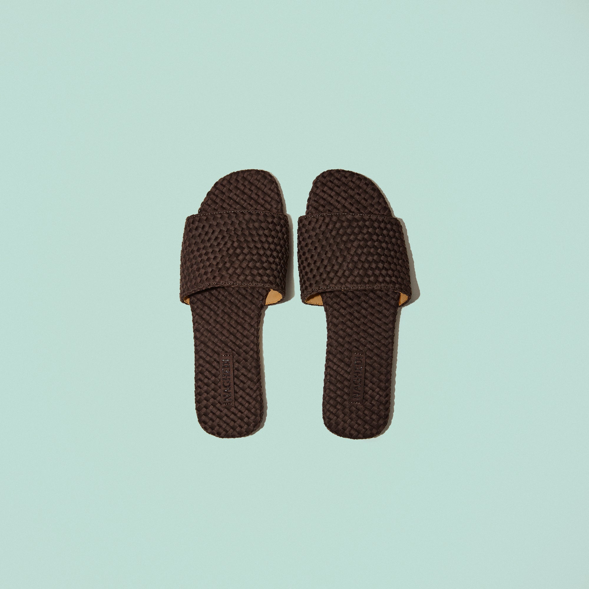 Side view of The St. Barths Slide in Chocolate, a dark chocolate brown tone, featuring an open toe and square silhouette.