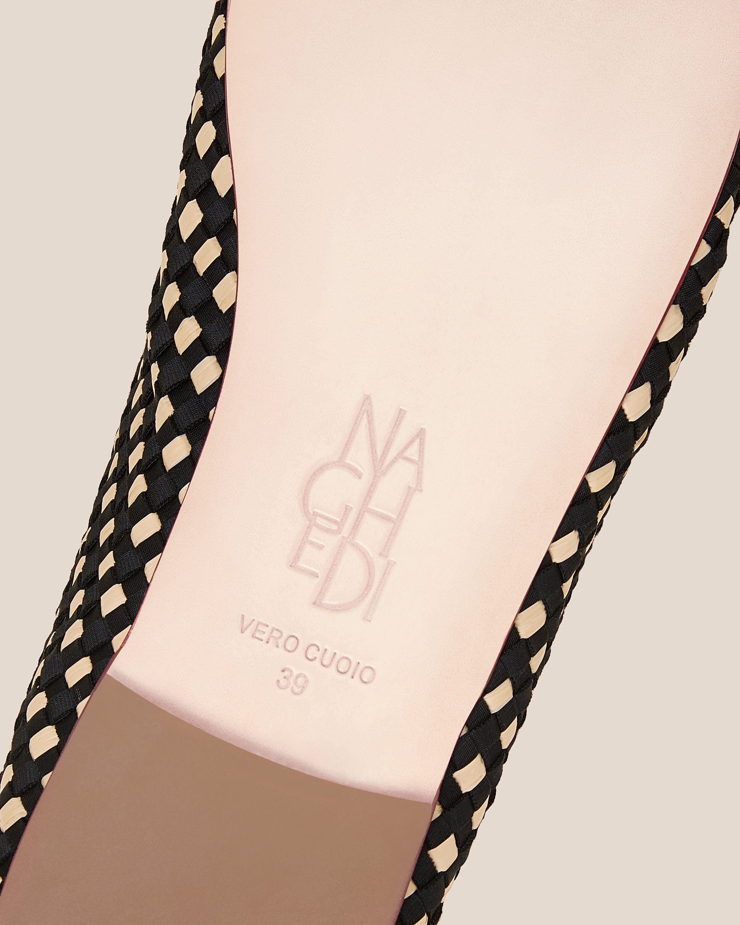 Shoe sole showing natural buffed leather sole, stamped NAGHEDI logo and size detail for The Nomad Ballet Flat in Costa.