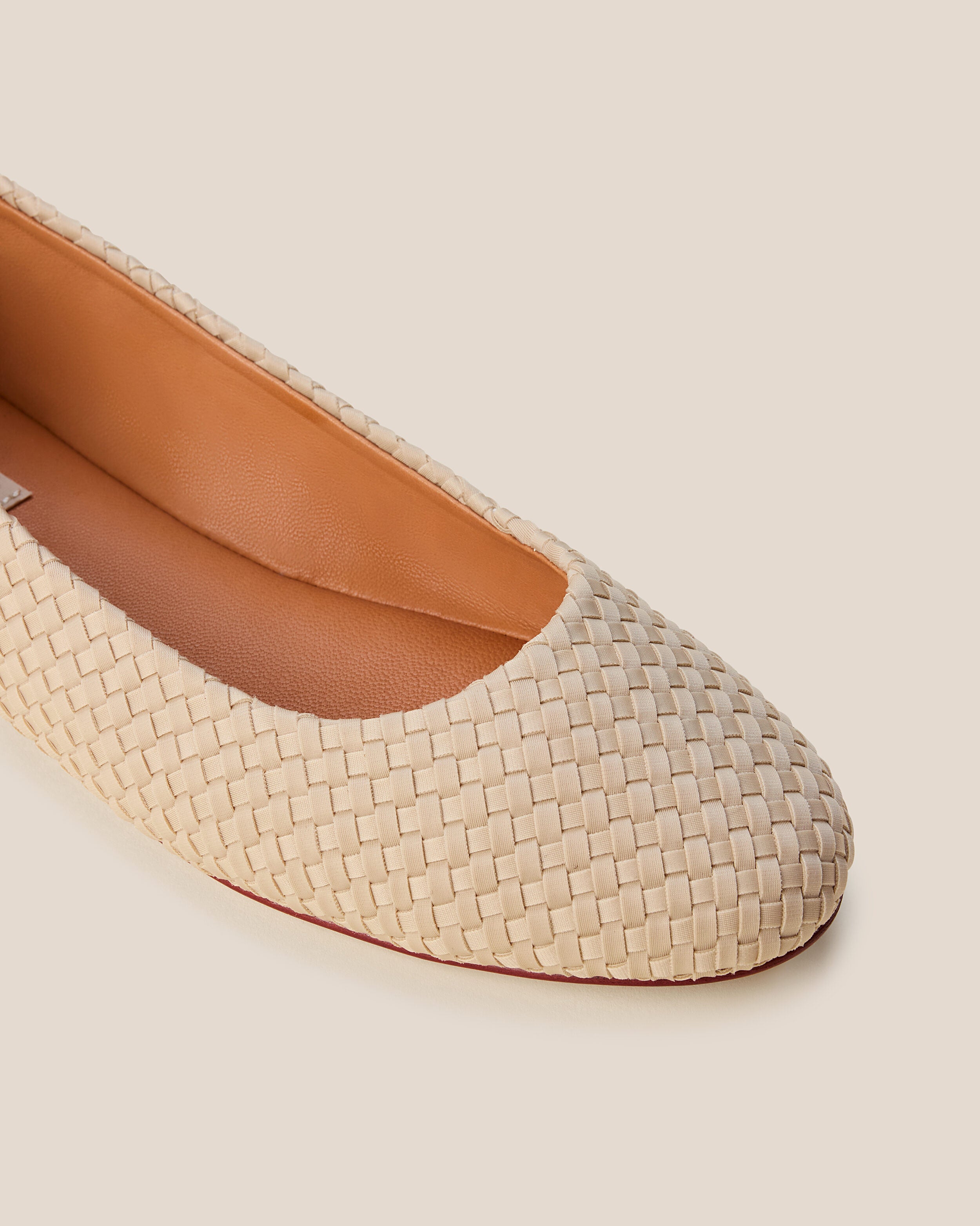 Close-up of The Nomad Ballet Flat in Ecru showing its closed toe and square silhouette.