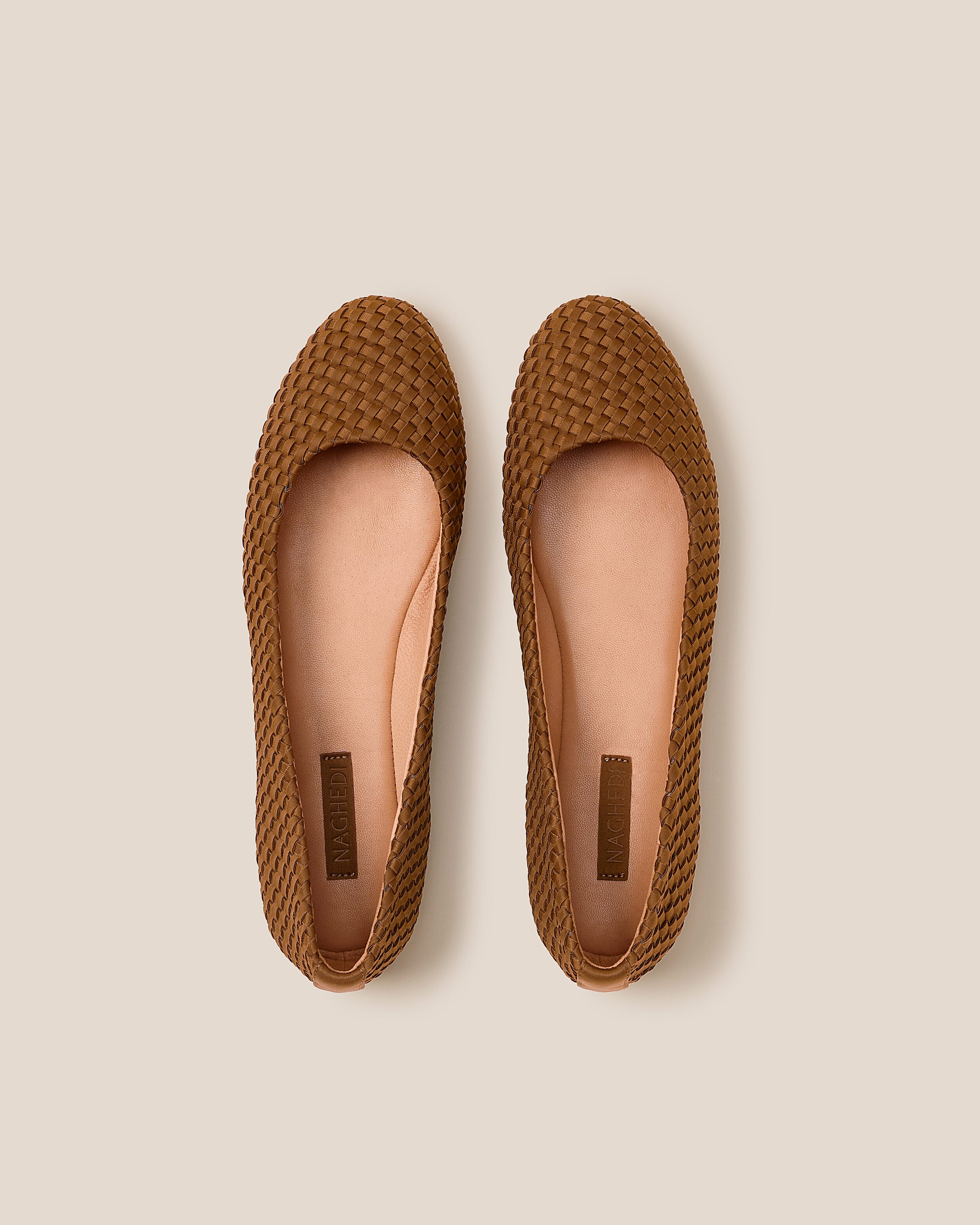 Top view of pair of The Nomad Ballet Flat in Teak showing the natural tanned leather insole.