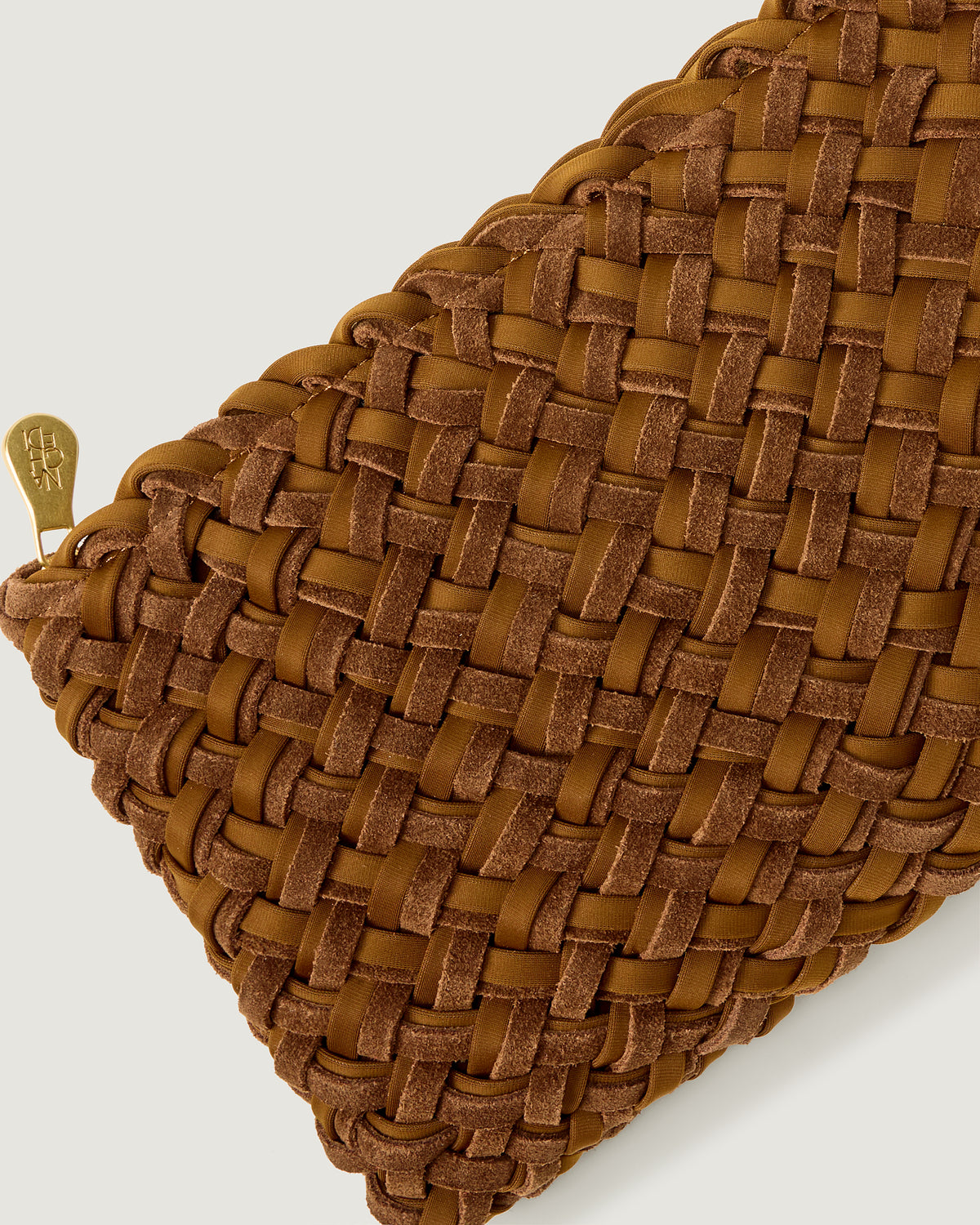 Close-up of included matching woven suede and neoprene zippered pouch.