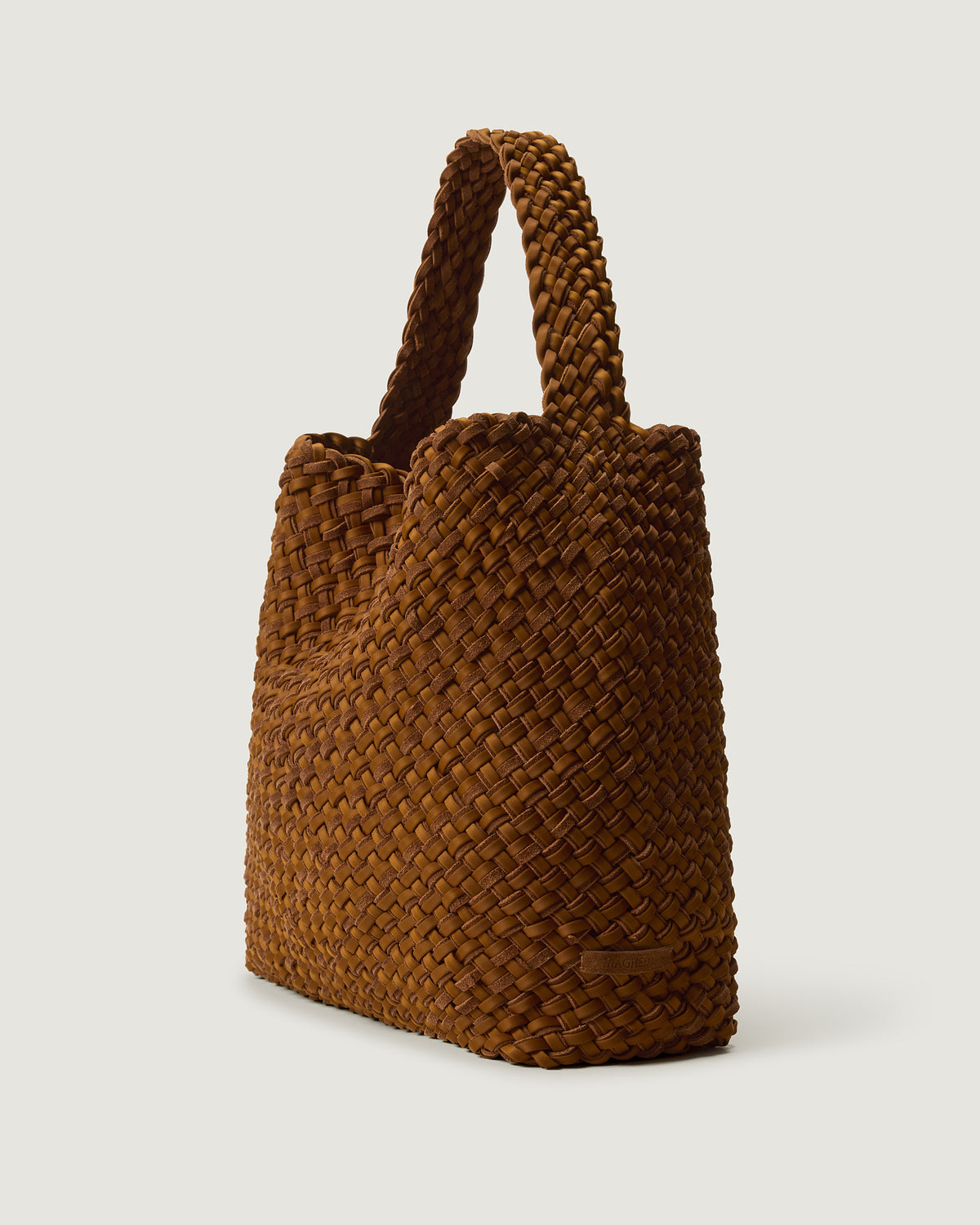 Nomad Large Hobo in Teak shown from a side angle, highlighting its handwoven neoprene and suede construction and open top with magnetic snap closure.