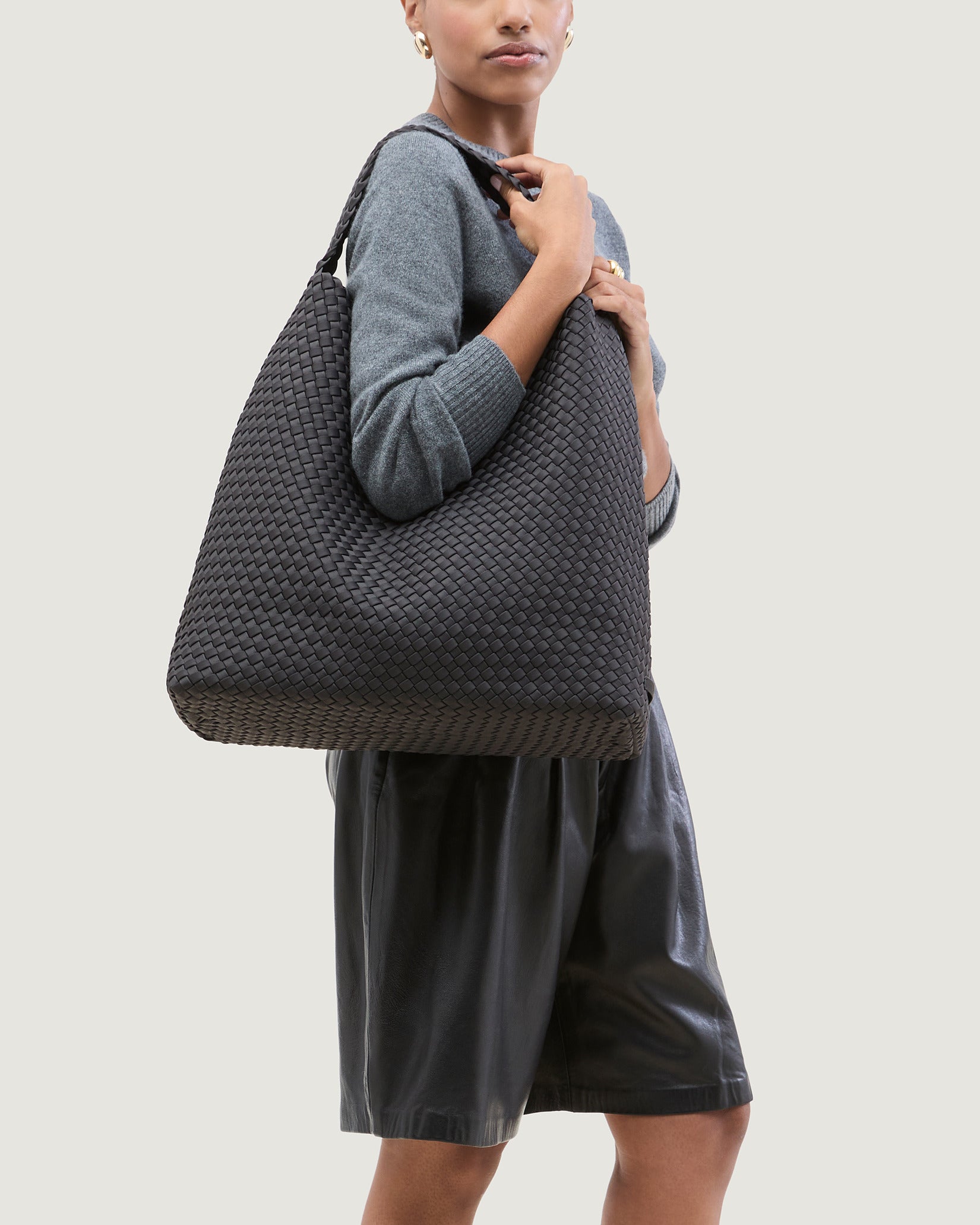 Nomad Large Hobo Bag in Ash shown on model to illustrate scale and soft silhouette.