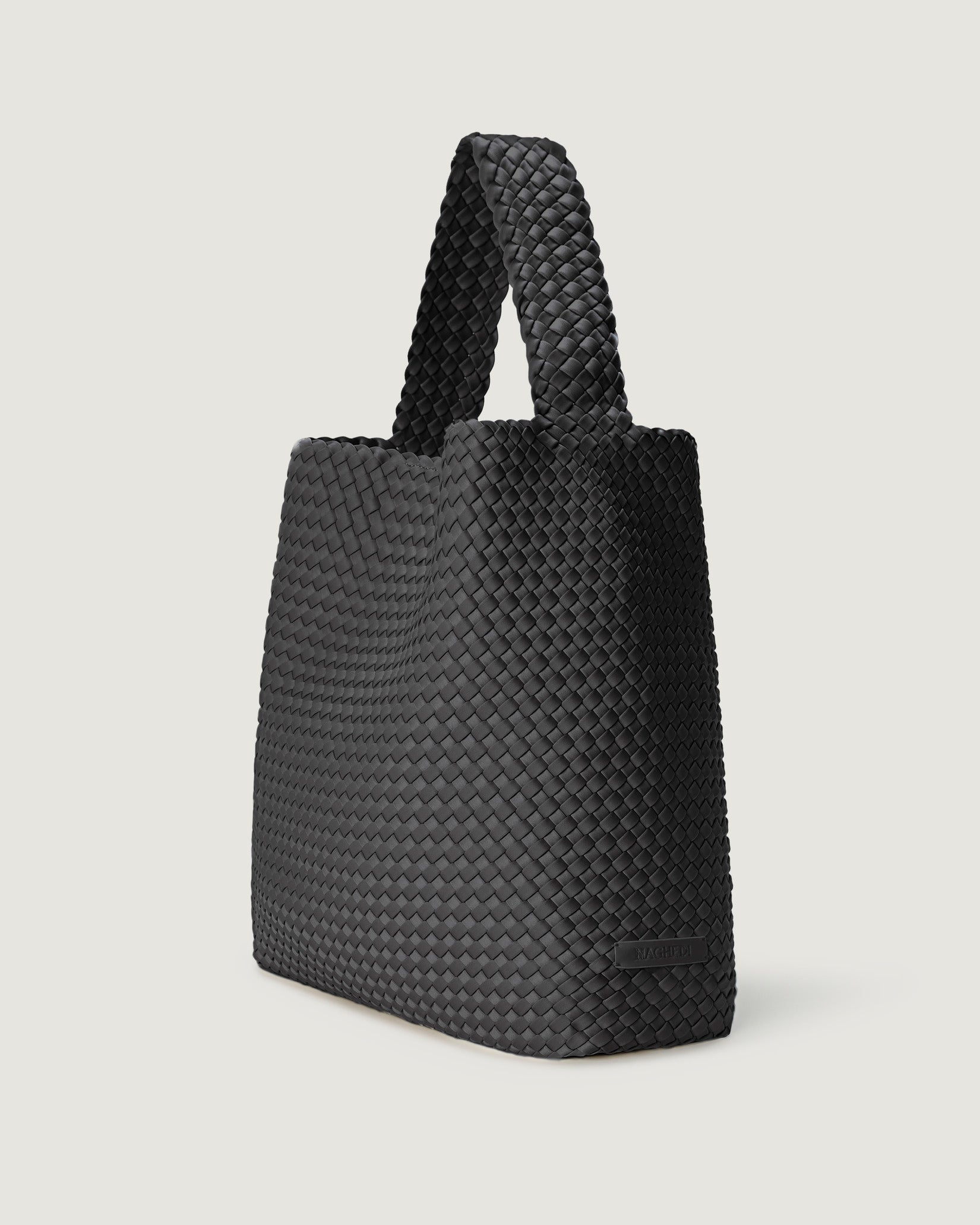 Nomad Large Hobo Bag in Ash shown from a side angle, highlighting its handwoven neoprene and open top with magnetic snap closure.