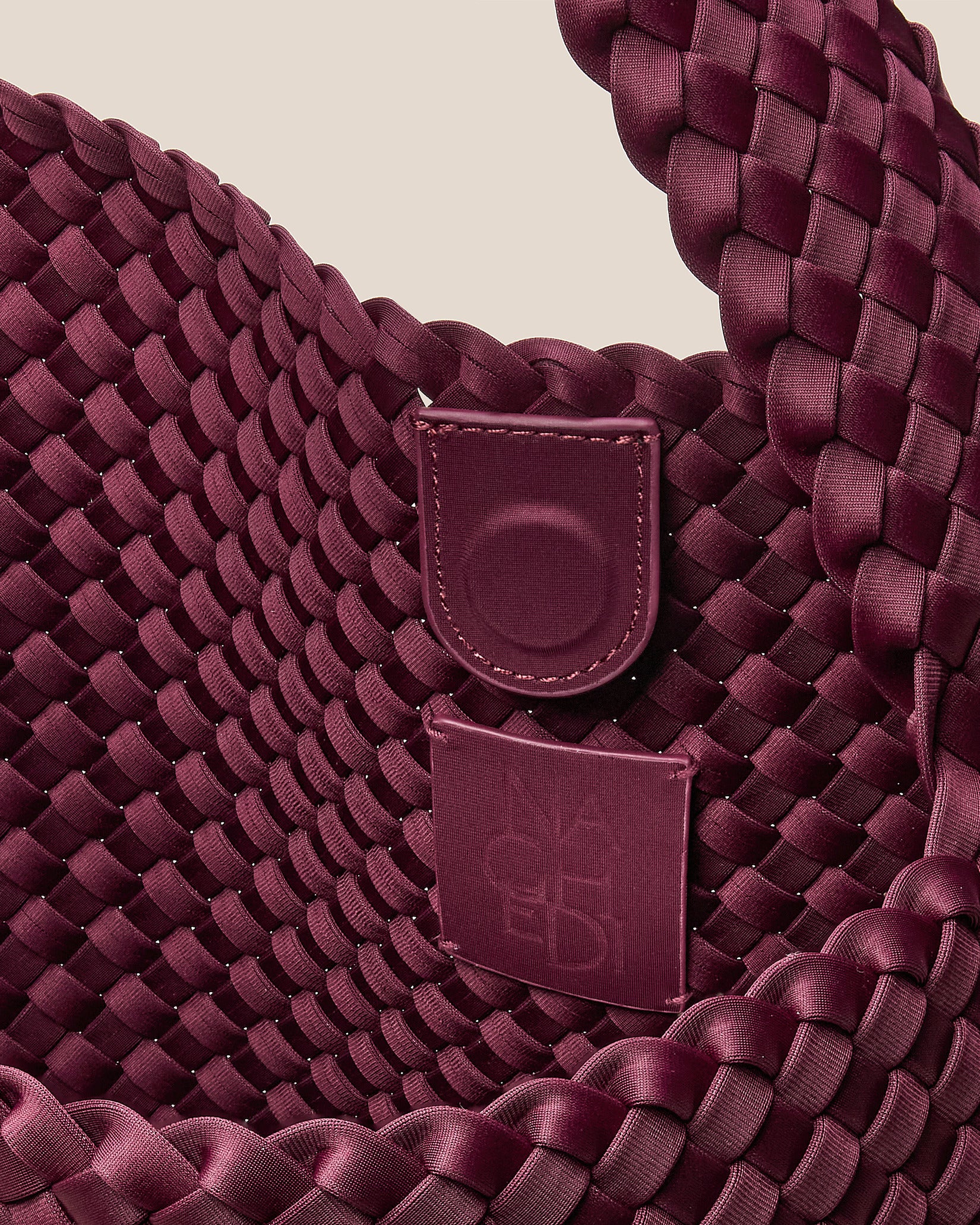 Interior close-up of Nomad Large Hobo Bag in Bordeaux showing its open top with magnetic snap closure, and unlined interior.