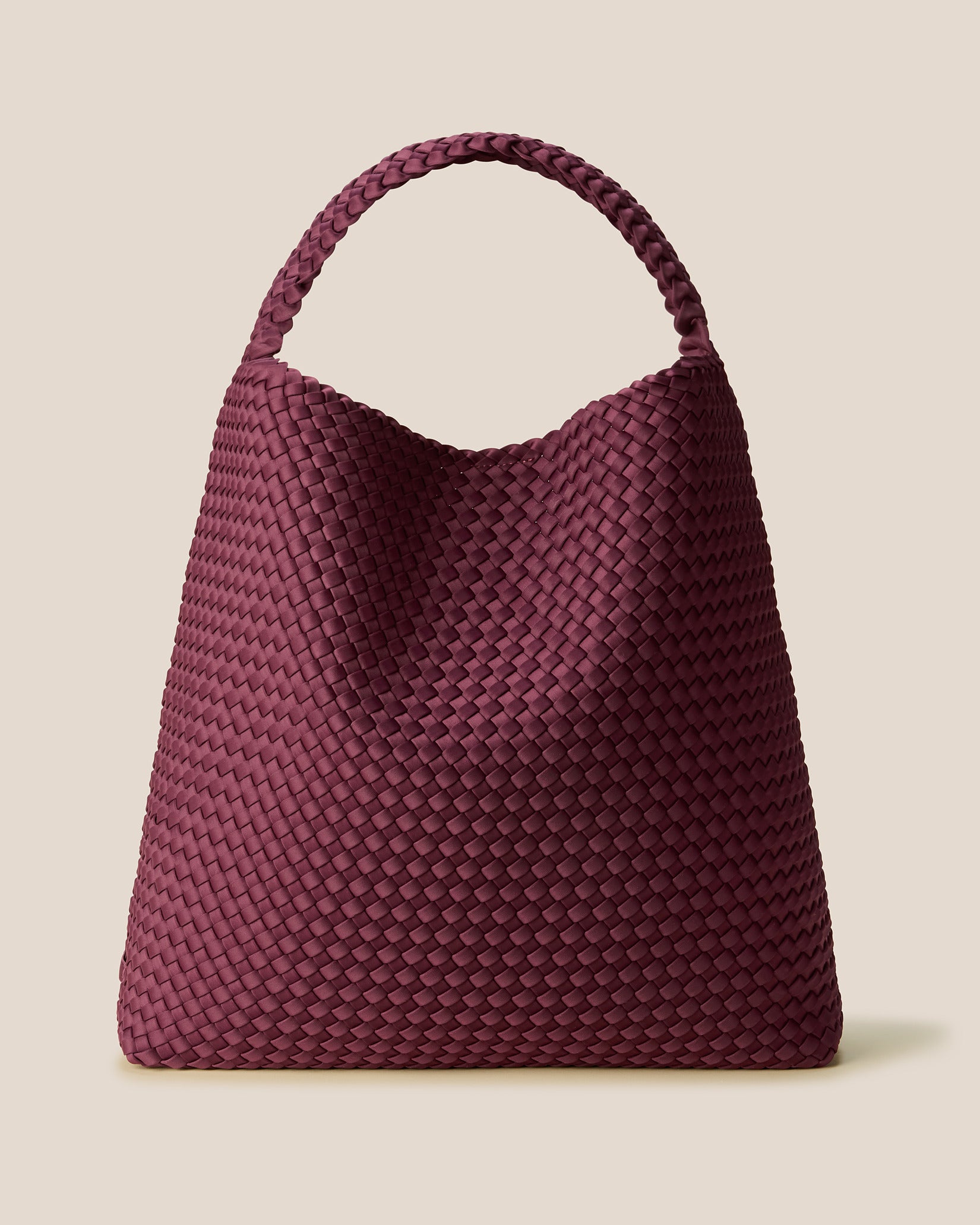 Nomad Large Hobo Bag in Bordeaux, a rich burgundy tone, in handwoven neoprene featuring an open top with magnetic snap closure, and handwoven shoulder strap lays comfortably flat.