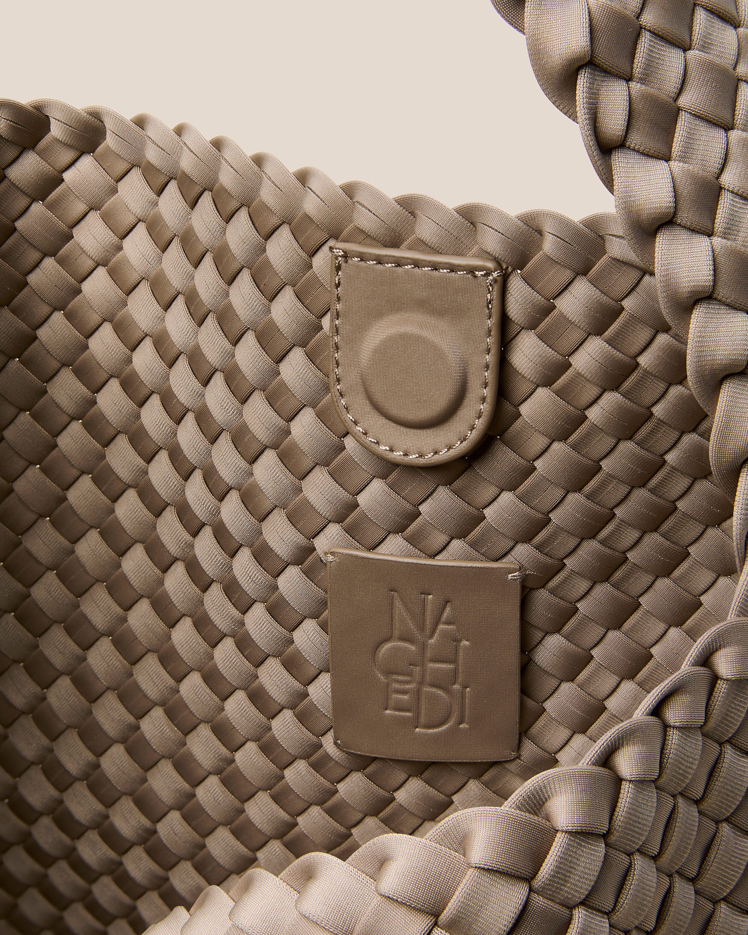 Interior close-up of Nomad Hobo in Cashmere showing its open top with magnetic snap closure, and unlined interior.