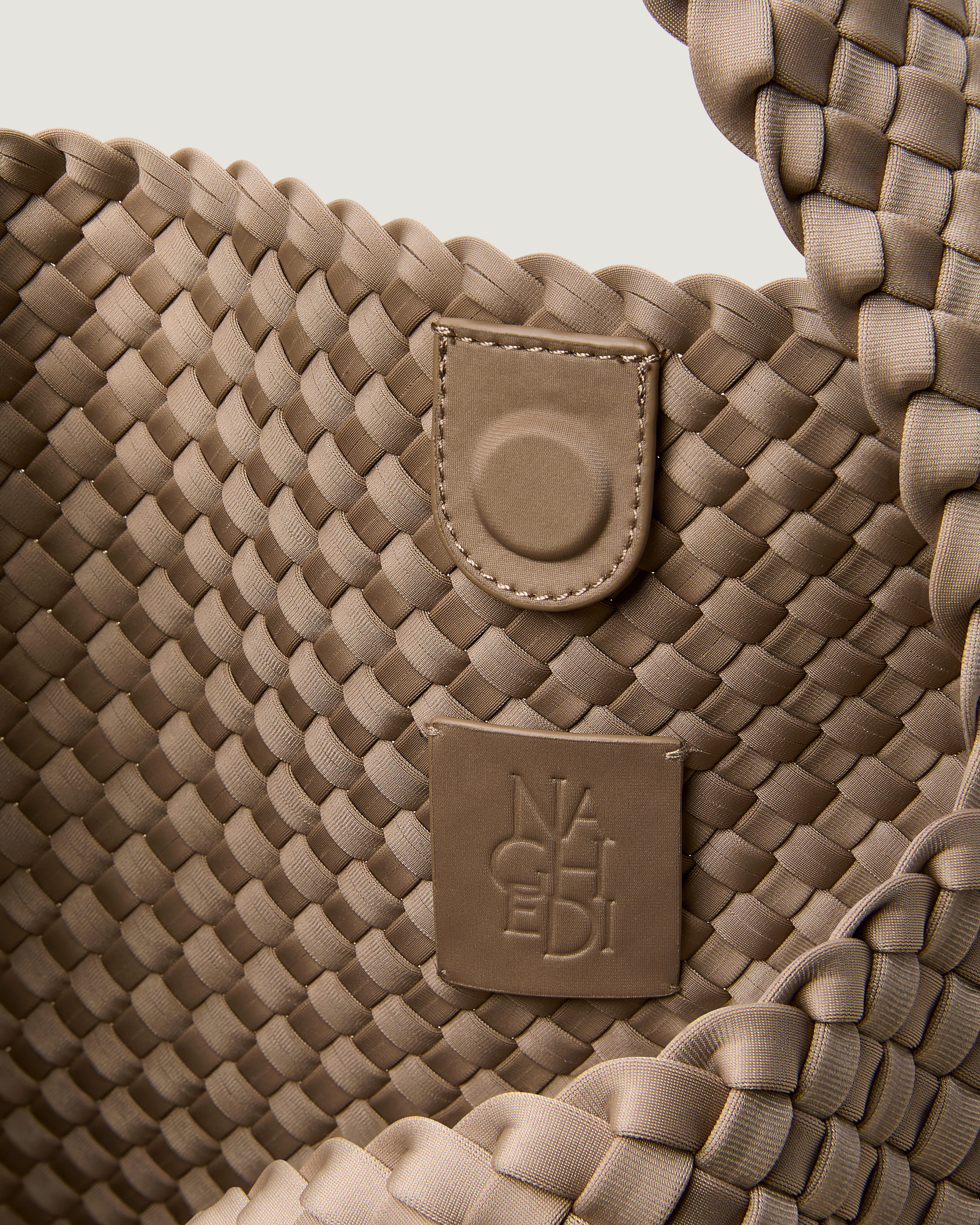 Interior close-up of Nomad Hobo in Cashmere showing its open top with magnetic snap closure, and unlined interior.