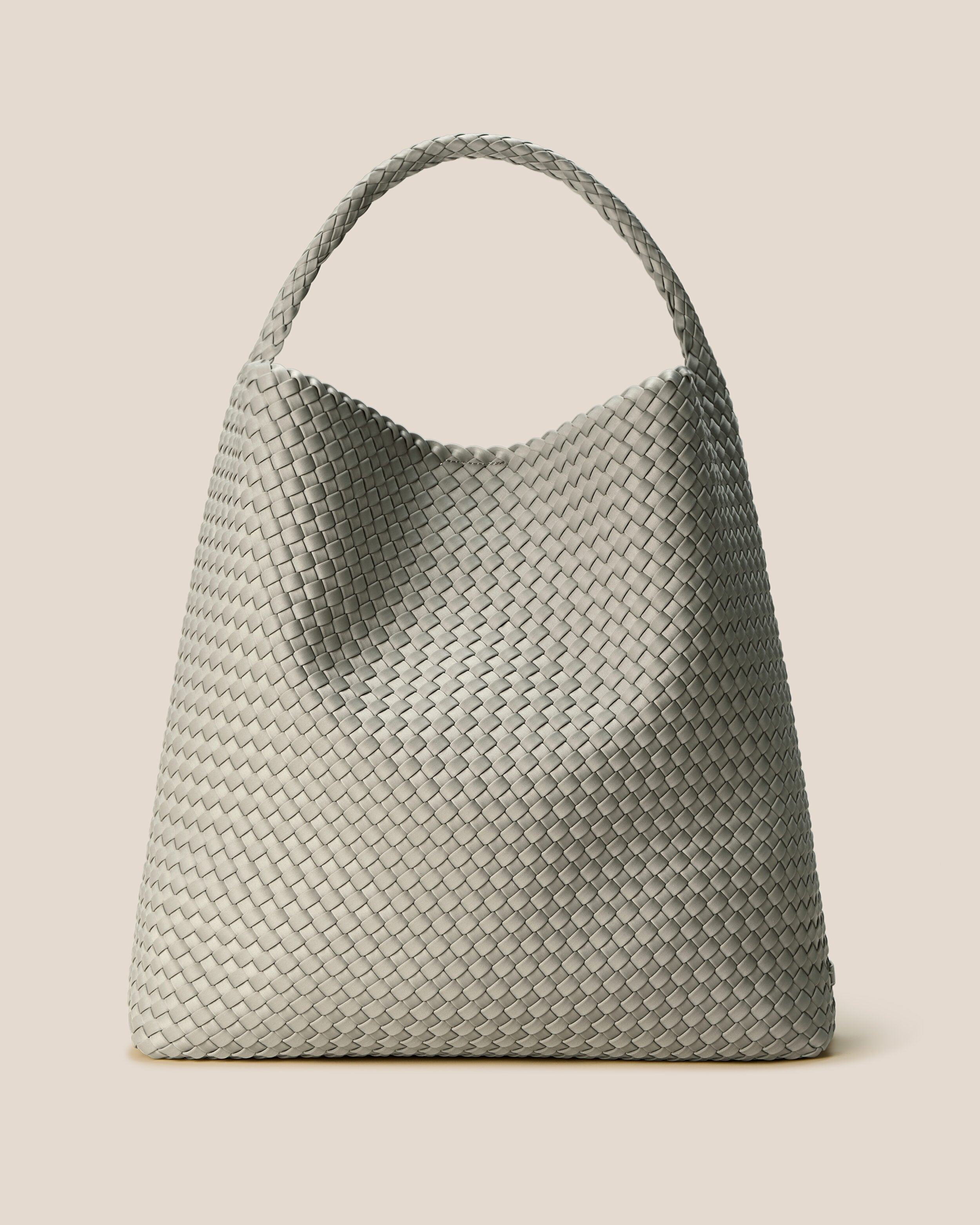 Nomad Hobo in Celadon, a light jade green tone, in handwoven neoprene, featuring an open top with magnetic snap closure, and handwoven shoulder strap lays comfortably flat.