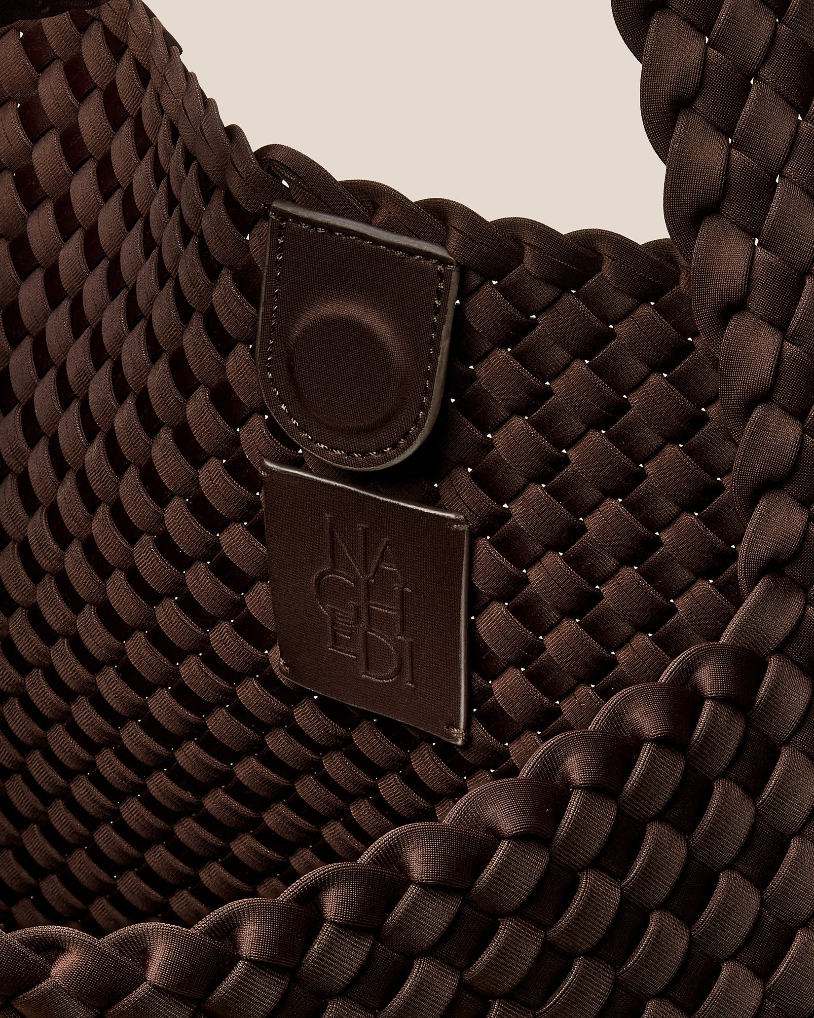 Interior close-up of Nomad Large Hobo Bag in Chocolate showing its open top with magnetic snap closure, and unlined interior.