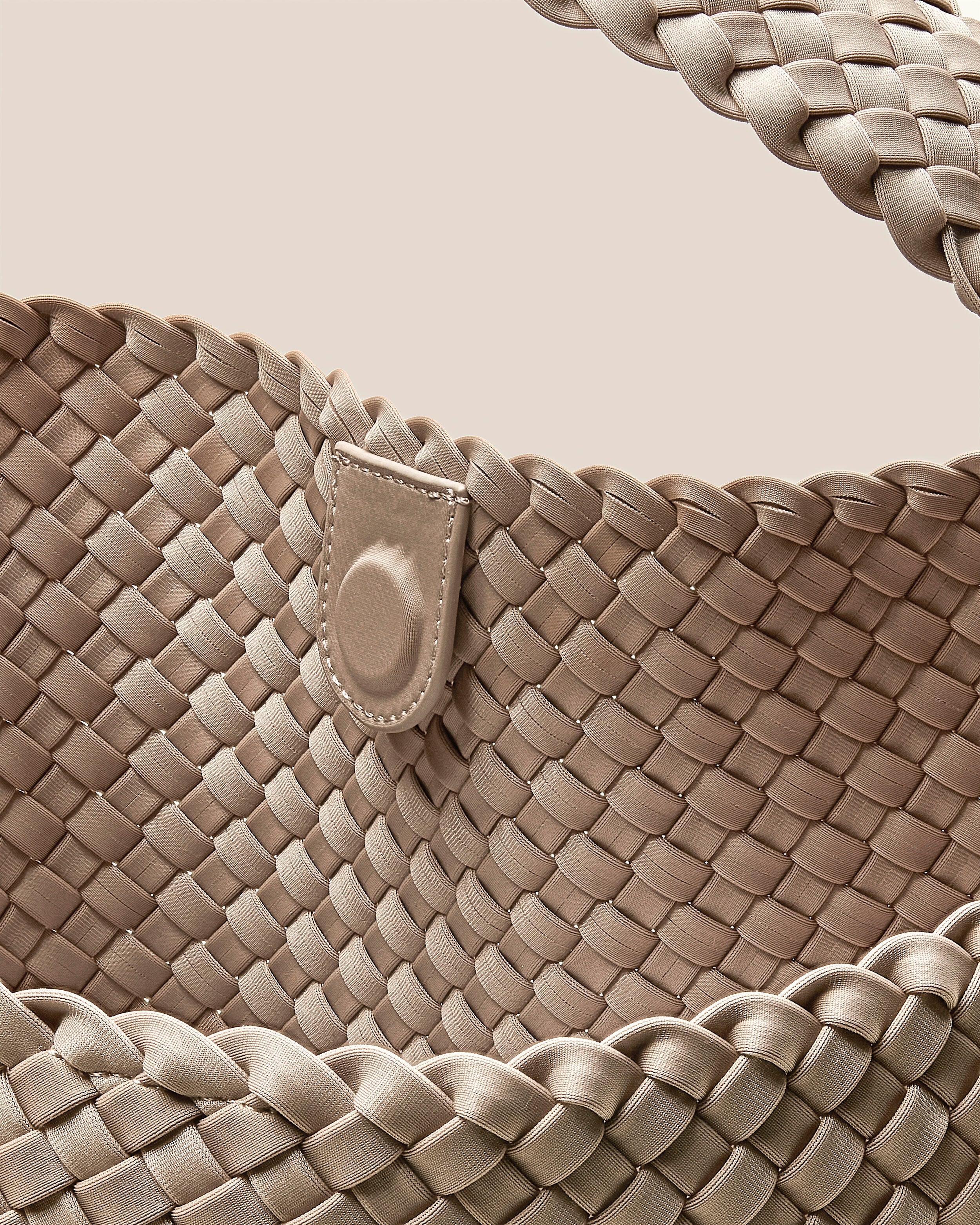 Interior close-up of Nomad Hobo in Ecru showing its open top with magnetic snap closure, and unlined interior.