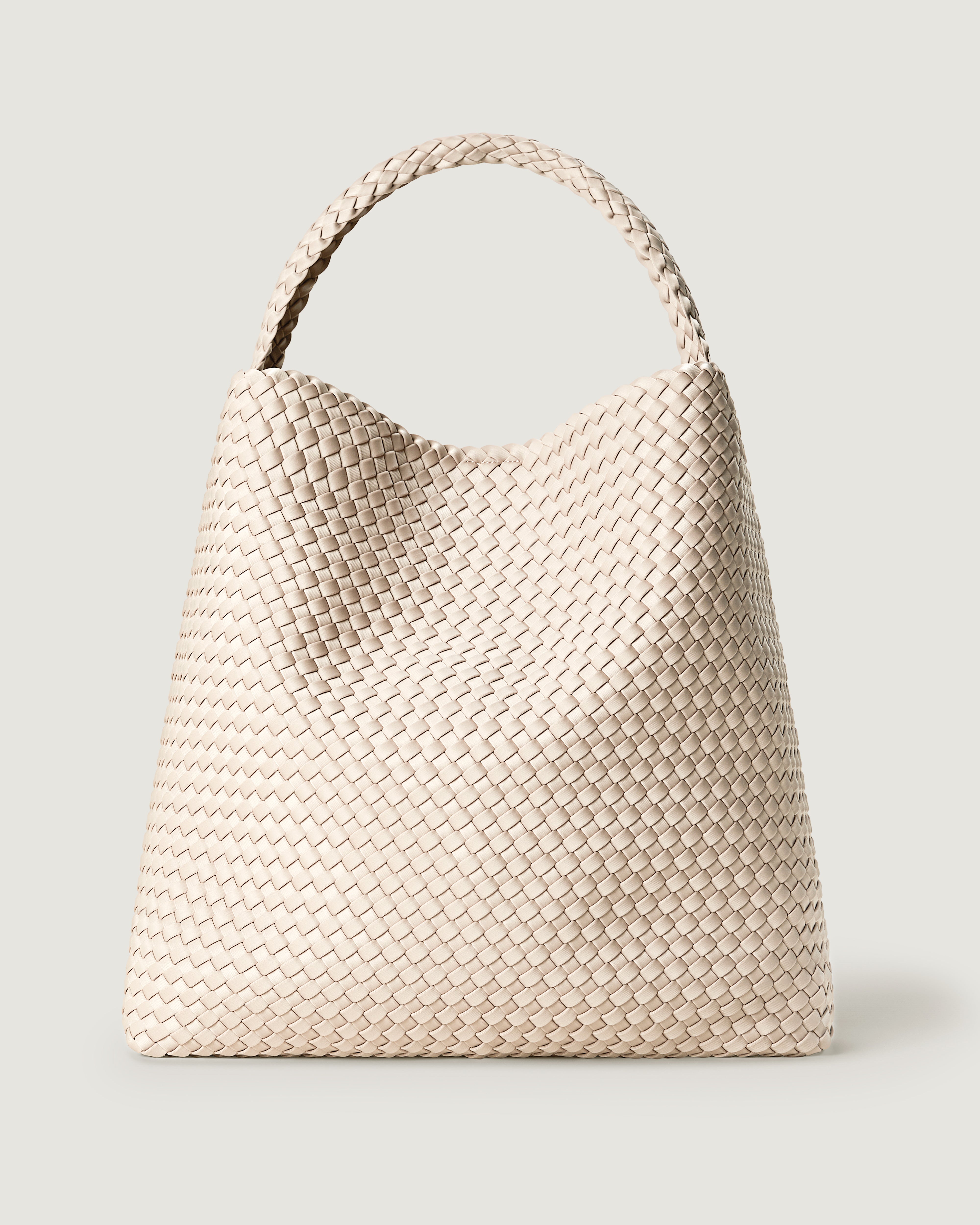 Nomad Hobo in Ecru, a cream tone, in handwoven neoprene, featuring an open top with magnetic snap closure, and handwoven shoulder strap lays comfortably flat.