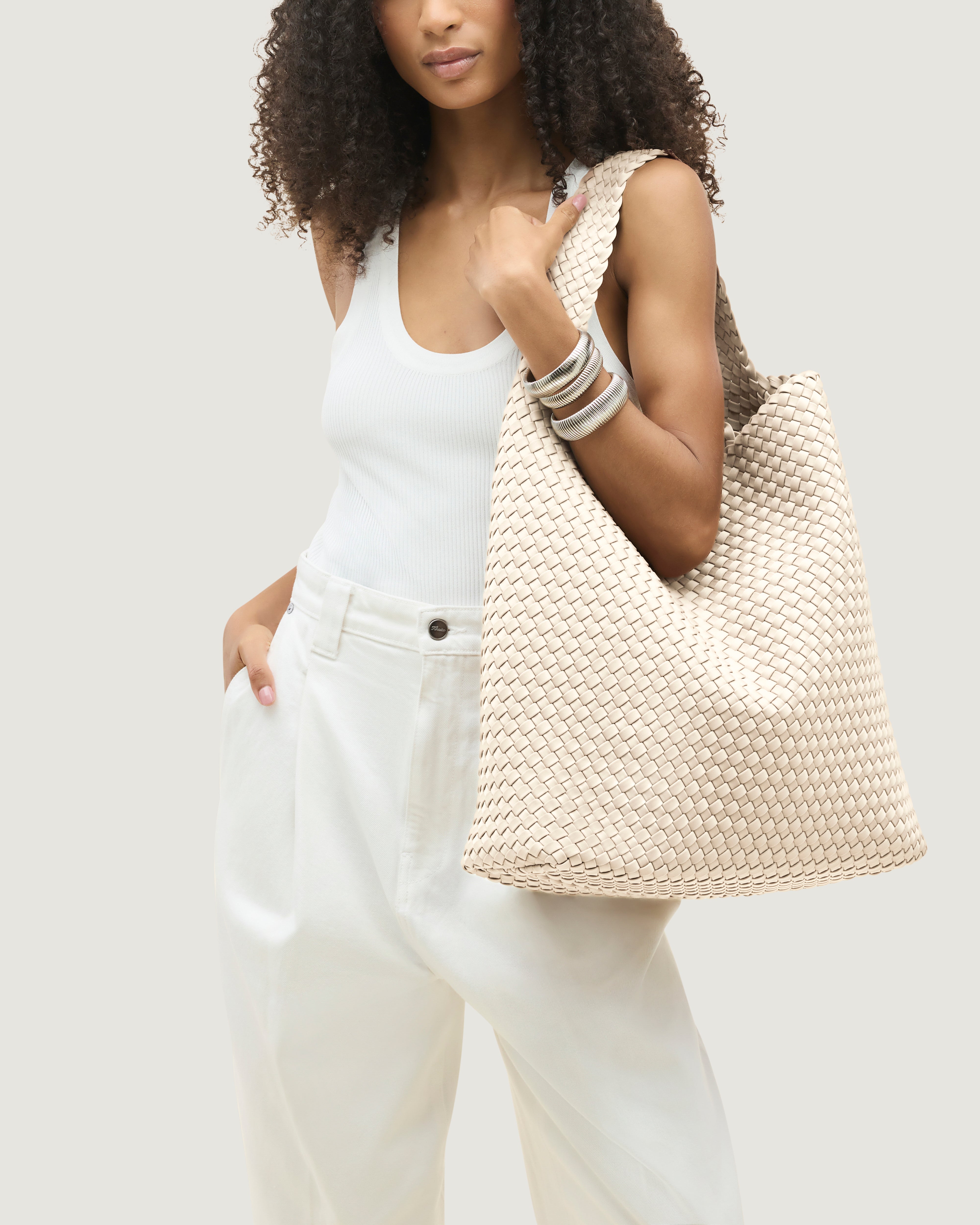 Nomad Hobo in Ecru shown on model to illustrate scale and soft silhouette.