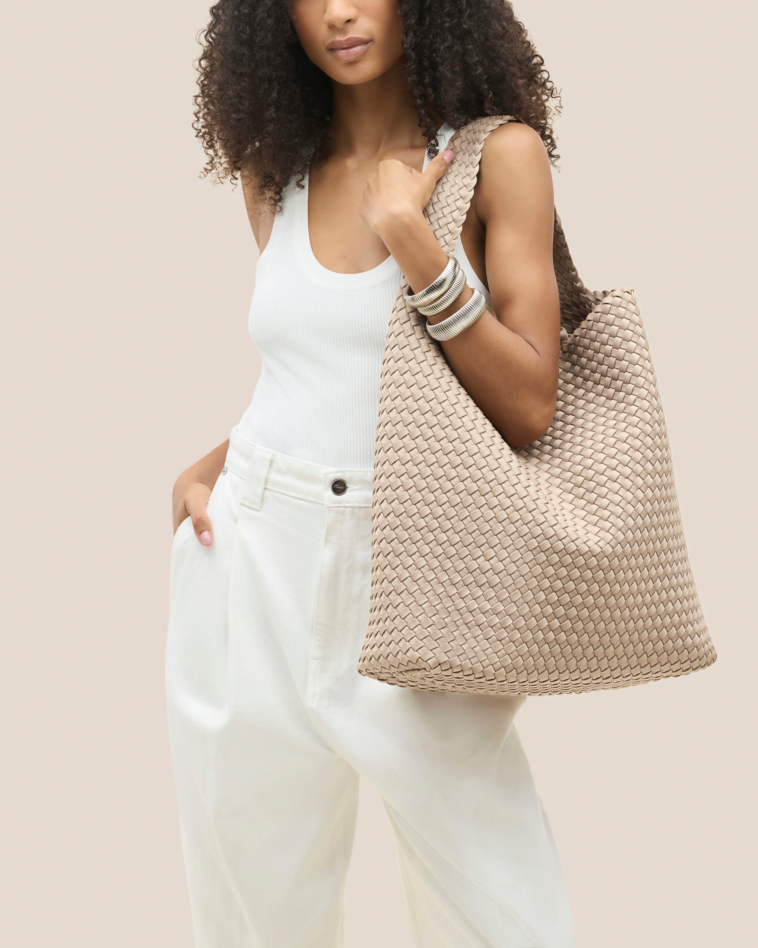 Nomad Hobo in Ecru shown on model to illustrate scale and soft silhouette.