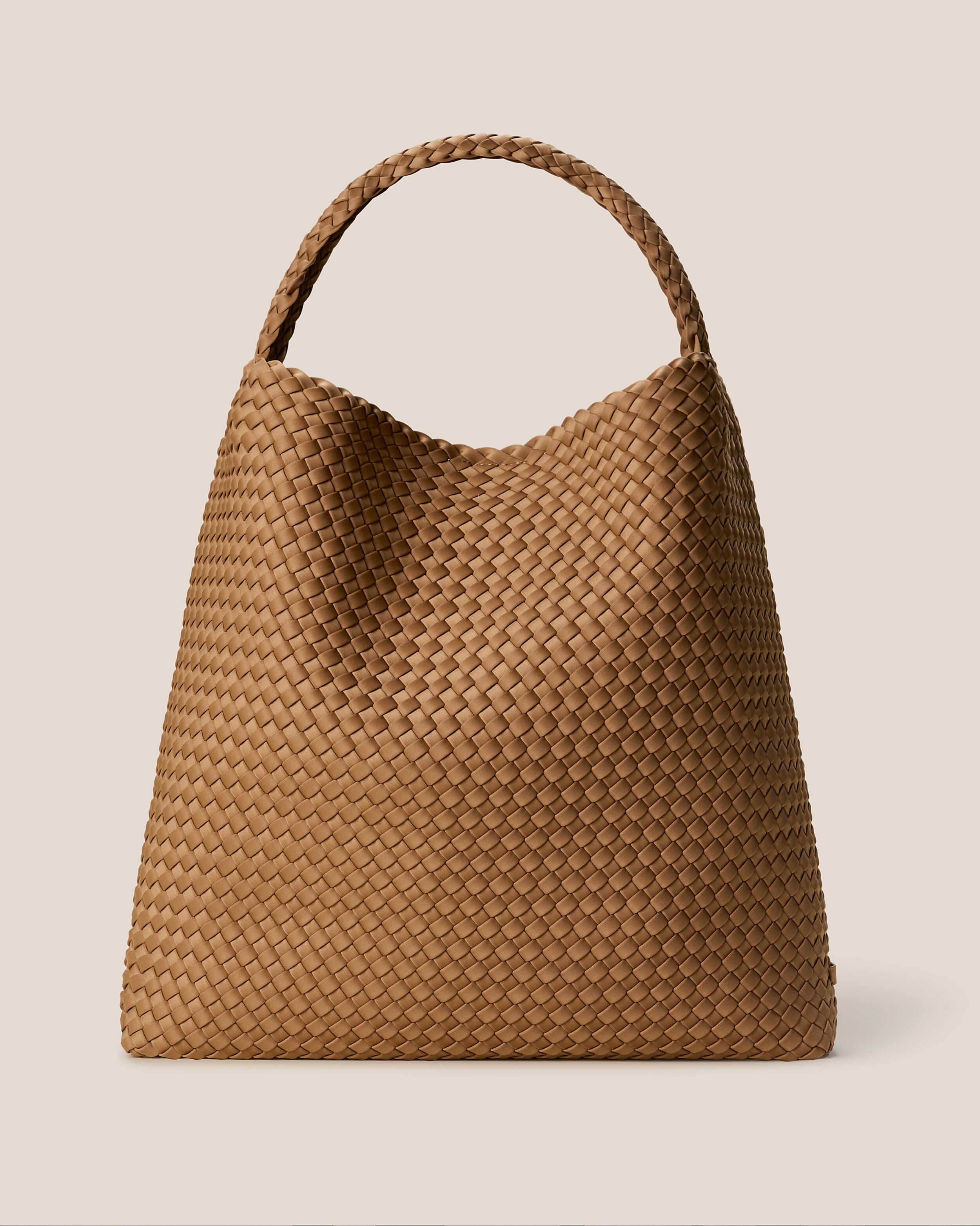 Nomad Hobo in Montauk, a tan brown tone, in handwoven neoprene, featuring an open top with magnetic snap closure, and handwoven shoulder strap lays comfortably flat.