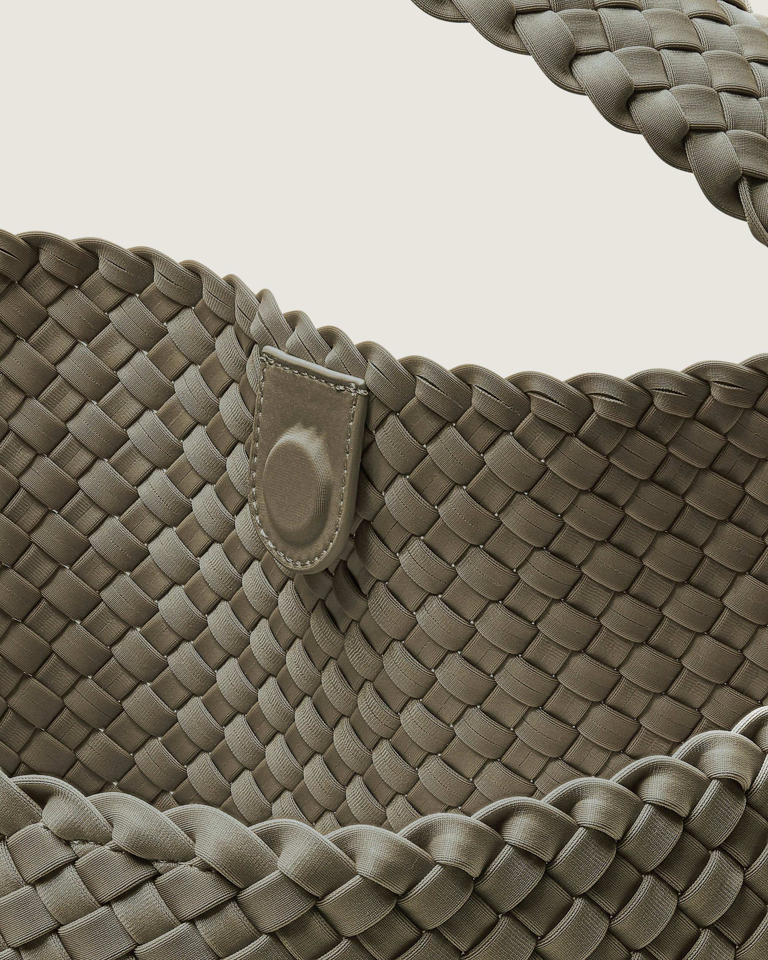 Interior close-up of Nomad Hobo in Olea showing its open top with magnetic snap closure, and unlined interior.