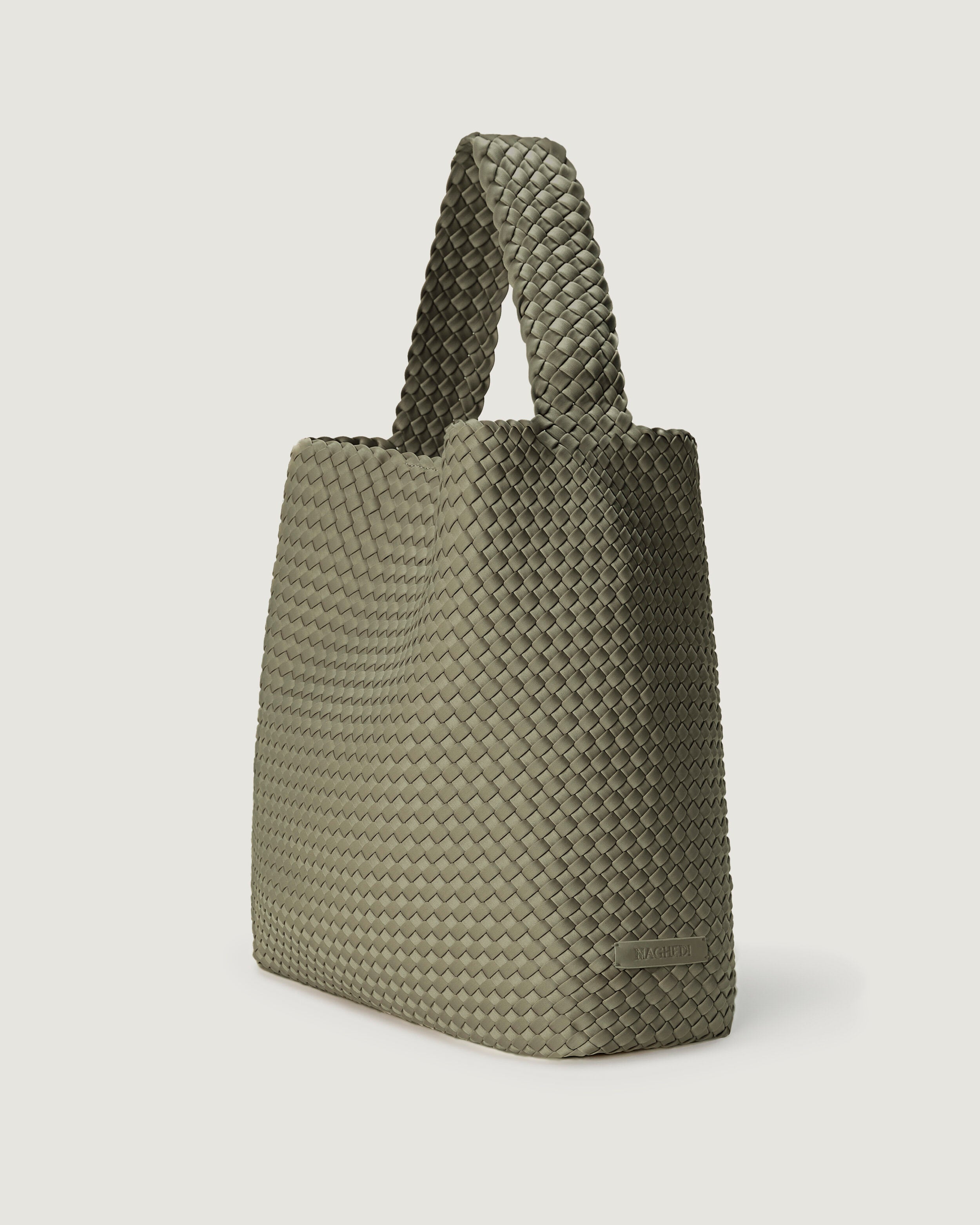 Nomad Hobo in Olea shown from a side angle, highlighting its handwoven neoprene construction and open top with magnetic snap closure.