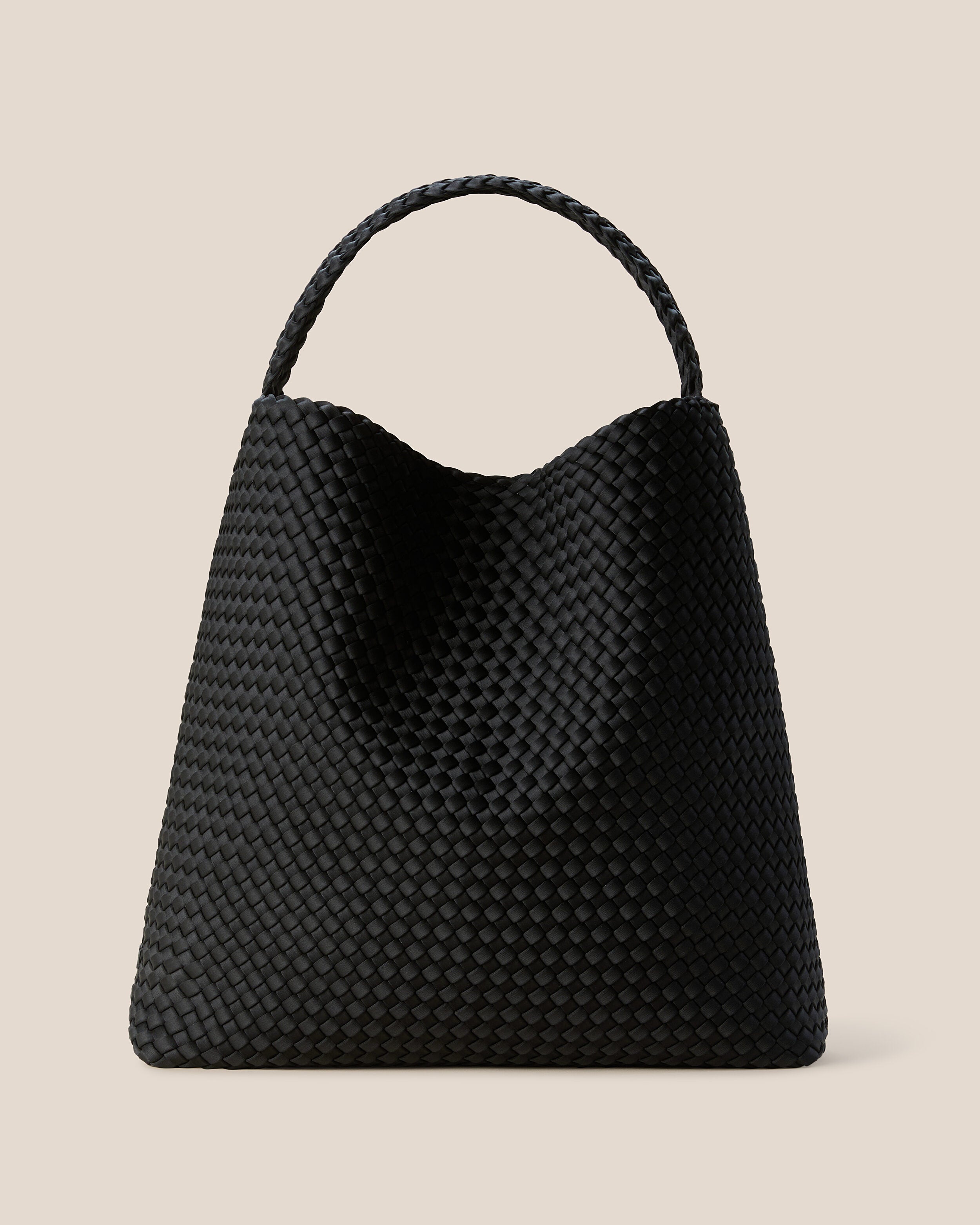 Nomad Hobo in Onyx, a true black tone, in handwoven neoprene, featuring an open top with magnetic snap closure, and handwoven shoulder strap lays comfortably flat.