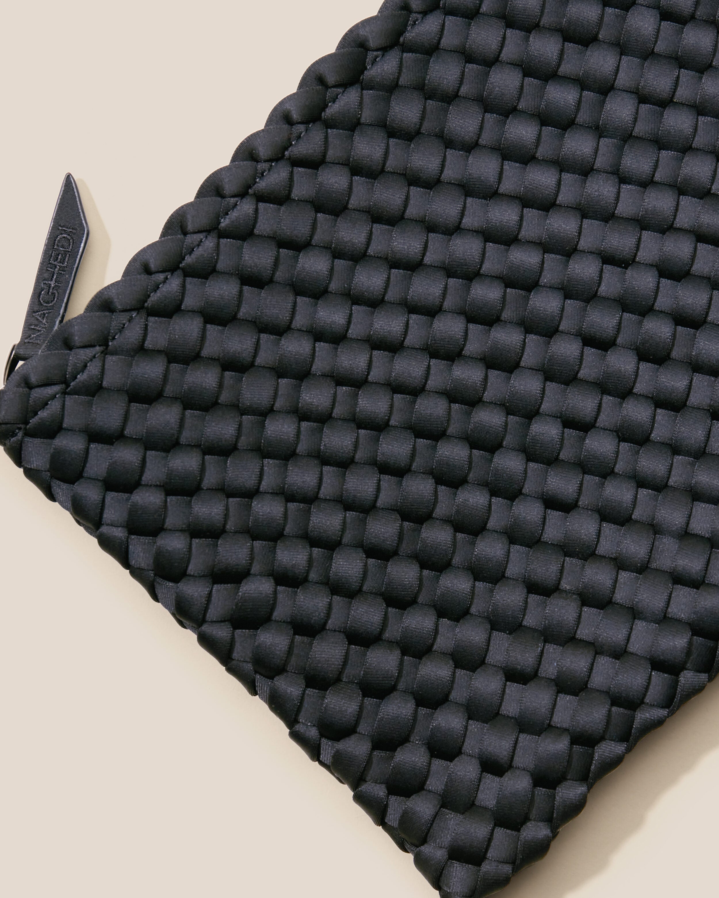 Close-up of included matching woven zippered pouch.