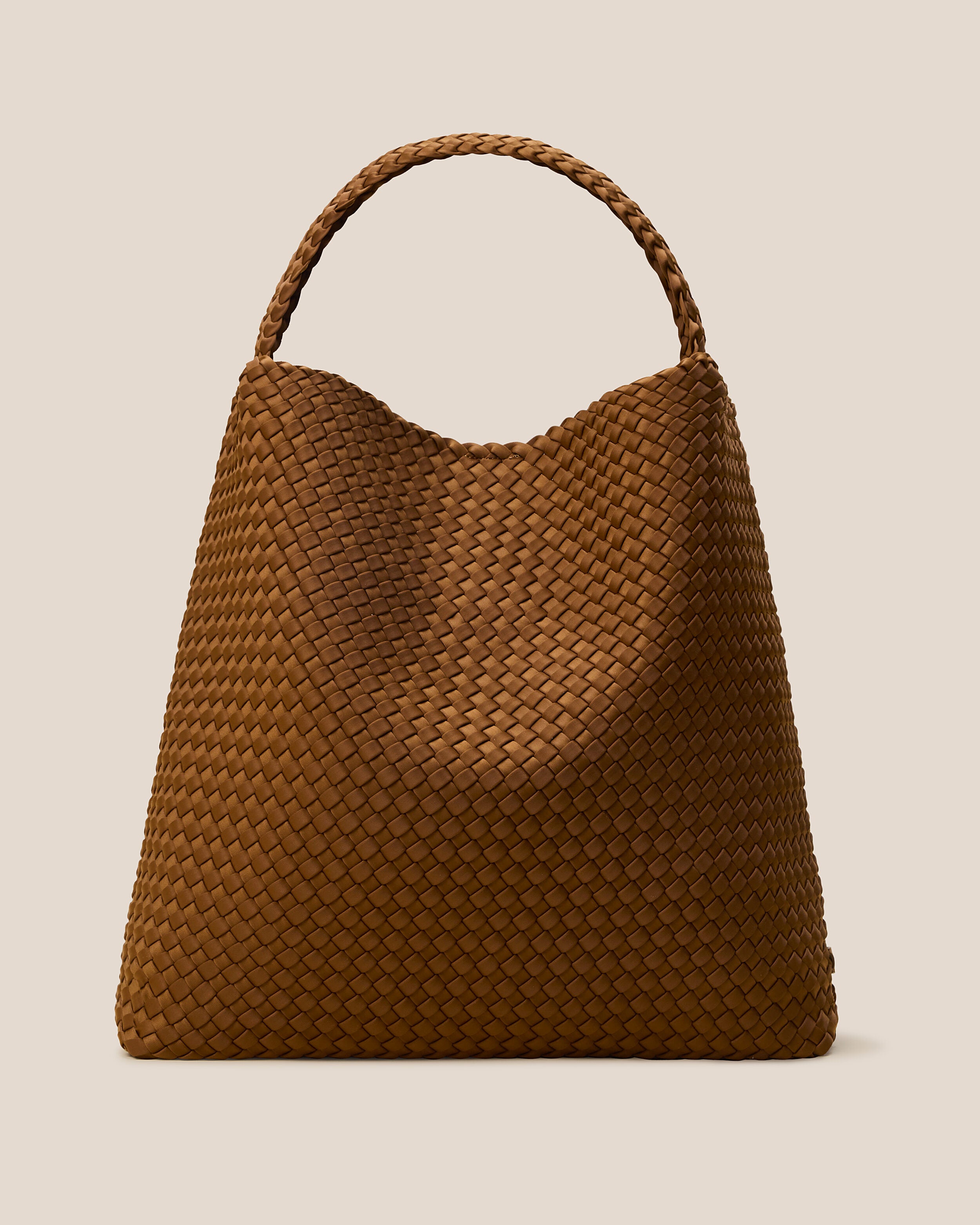 Nomad Hobo in Teak, a saddle brown tone, in handwoven neoprene, featuring an open top with magnetic snap closure, and handwoven shoulder strap lays comfortably flat.