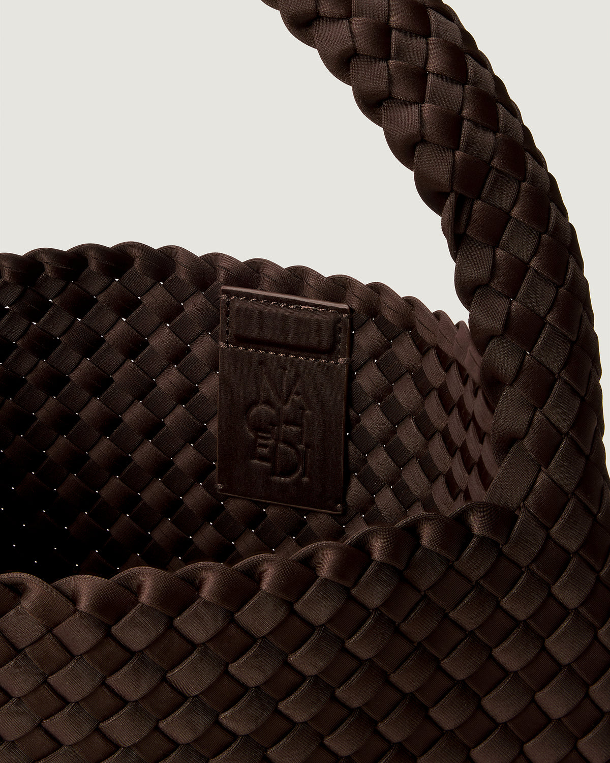 Interior close-up of Nomad Hobo in Chocolate showing its open top with magnetic snap closure, and unlined interior.