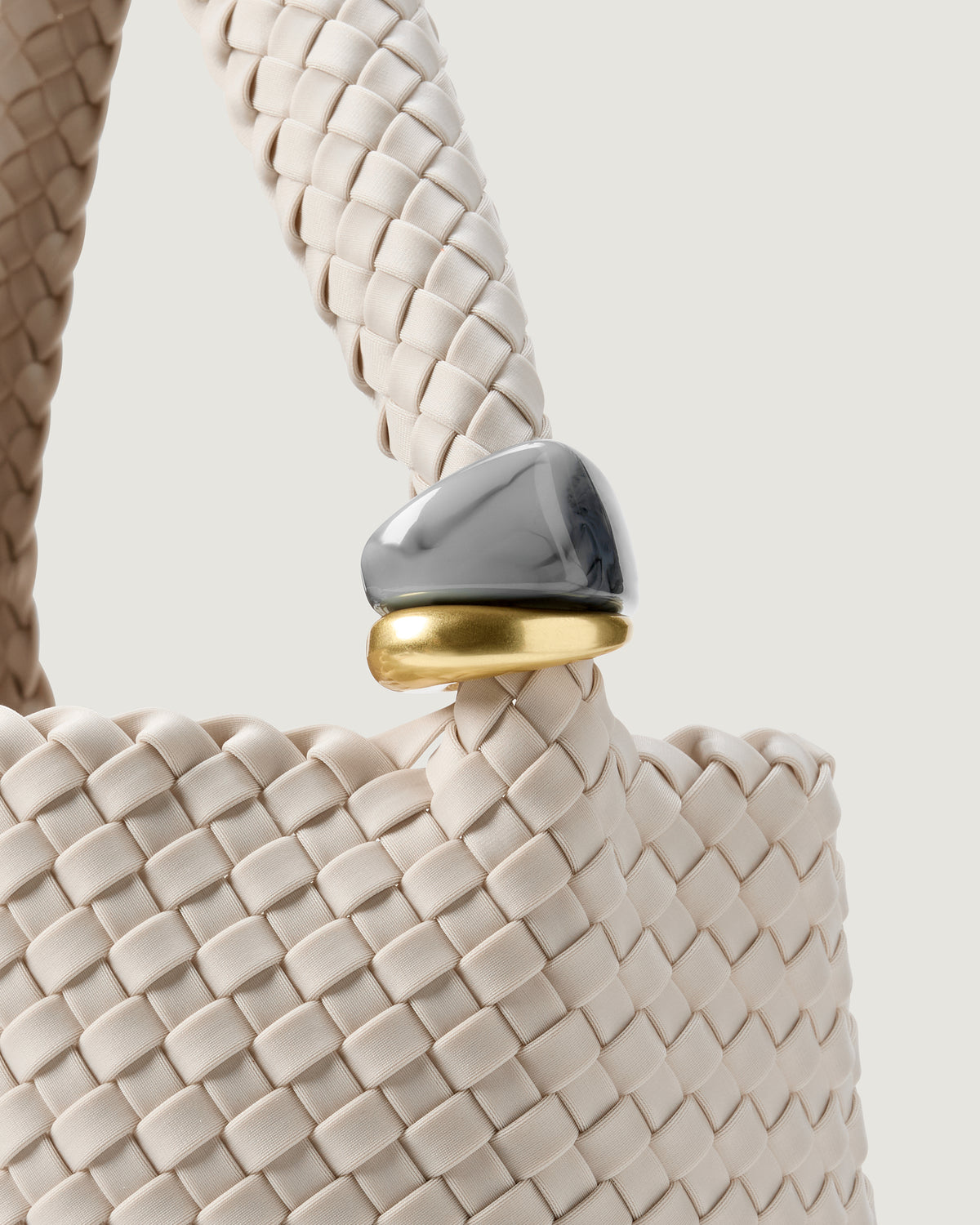 Close up of the Nomad Medium Hobo in Linen highlighting the two beads on the handle.