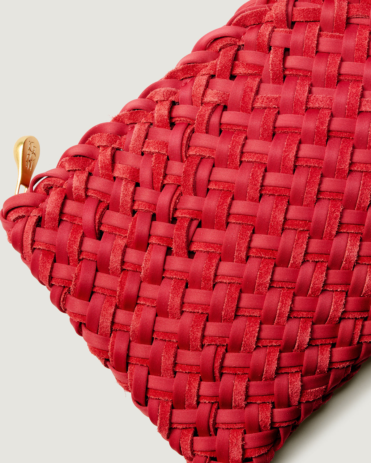 Close-up of included matching woven suede and neoprene zippered pouch.