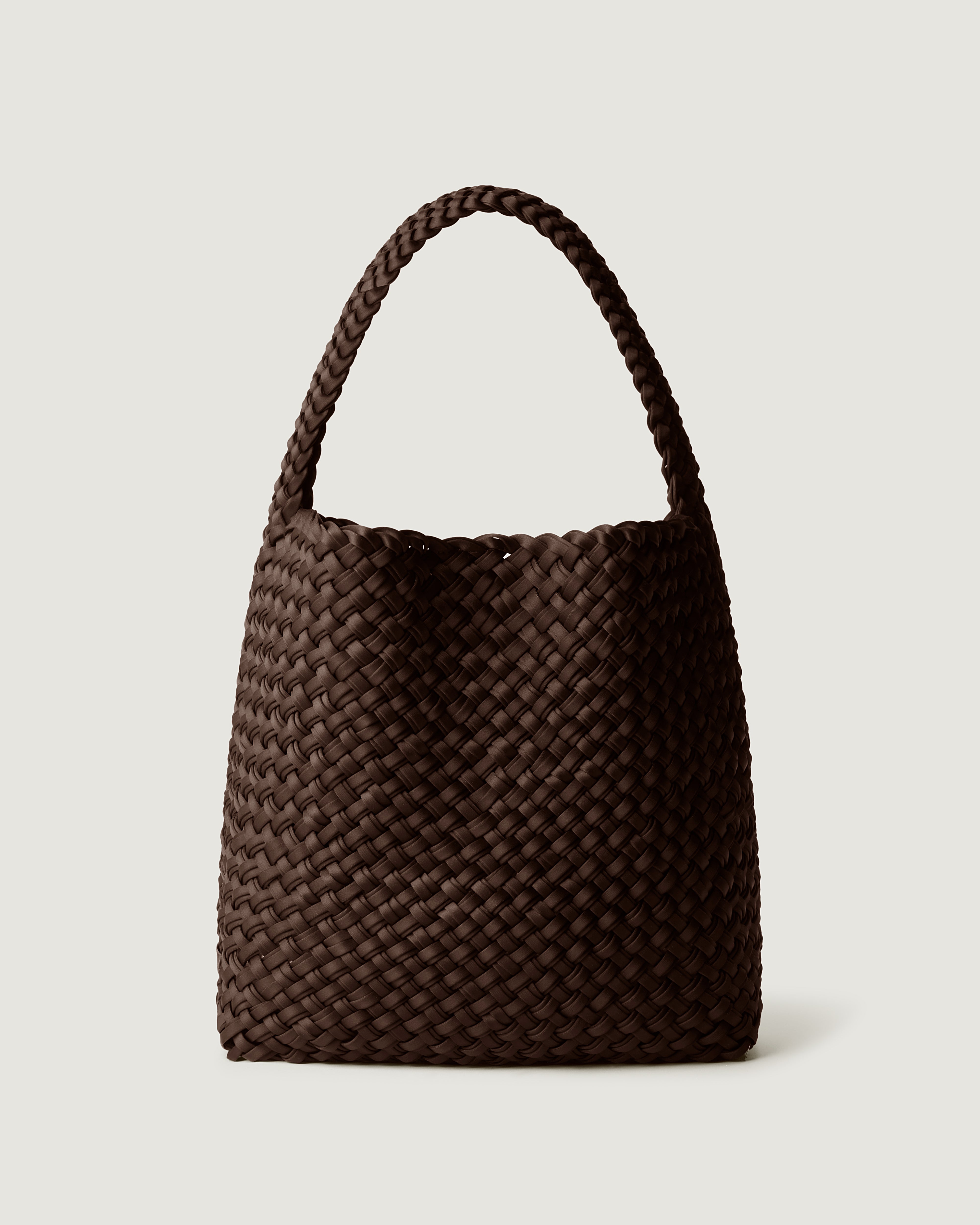 Nomad Hobo in Chocolate, handwoven from doubled strands of rich dark brown neoprene. Featuring an open top with magnetic snap closure, and handwoven shoulder strap lays comfortably flat.