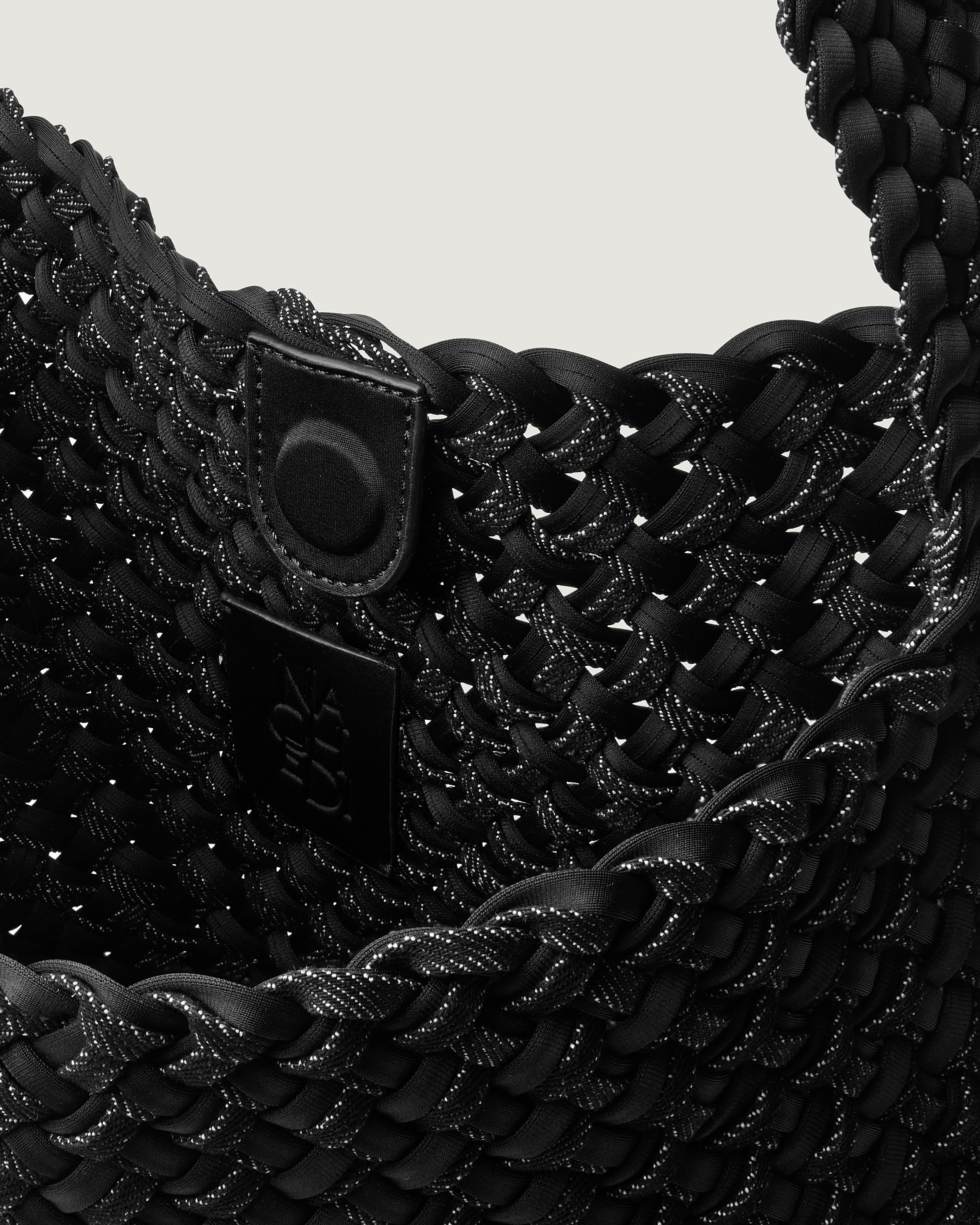 Interior close-up of Nomad Hobo in Jet showing its magnetic closure, and unlined interior.