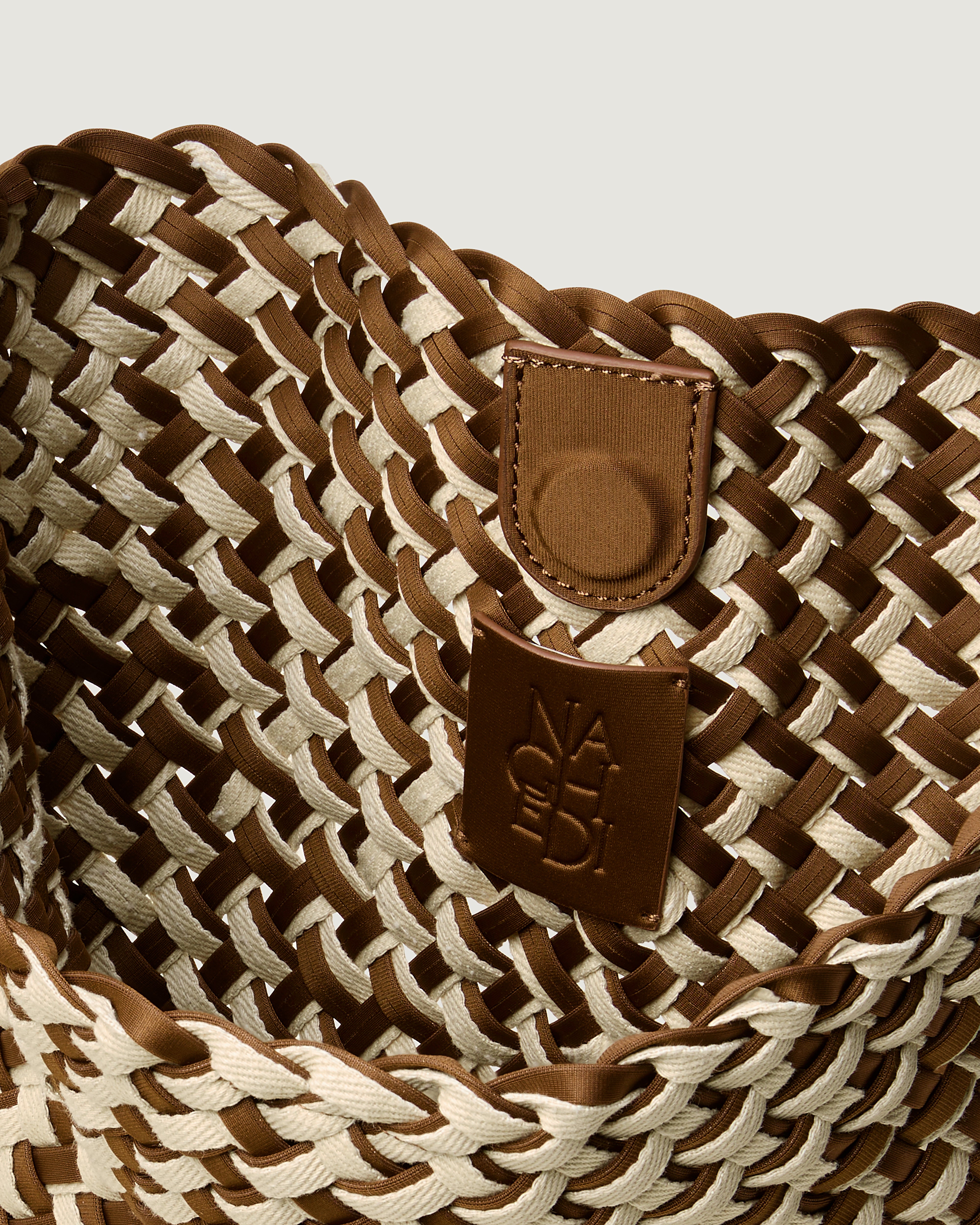 Interior close-up of Nomad Hobo in Carmel showing its open top with magnetic snap closure, and unlined interior.