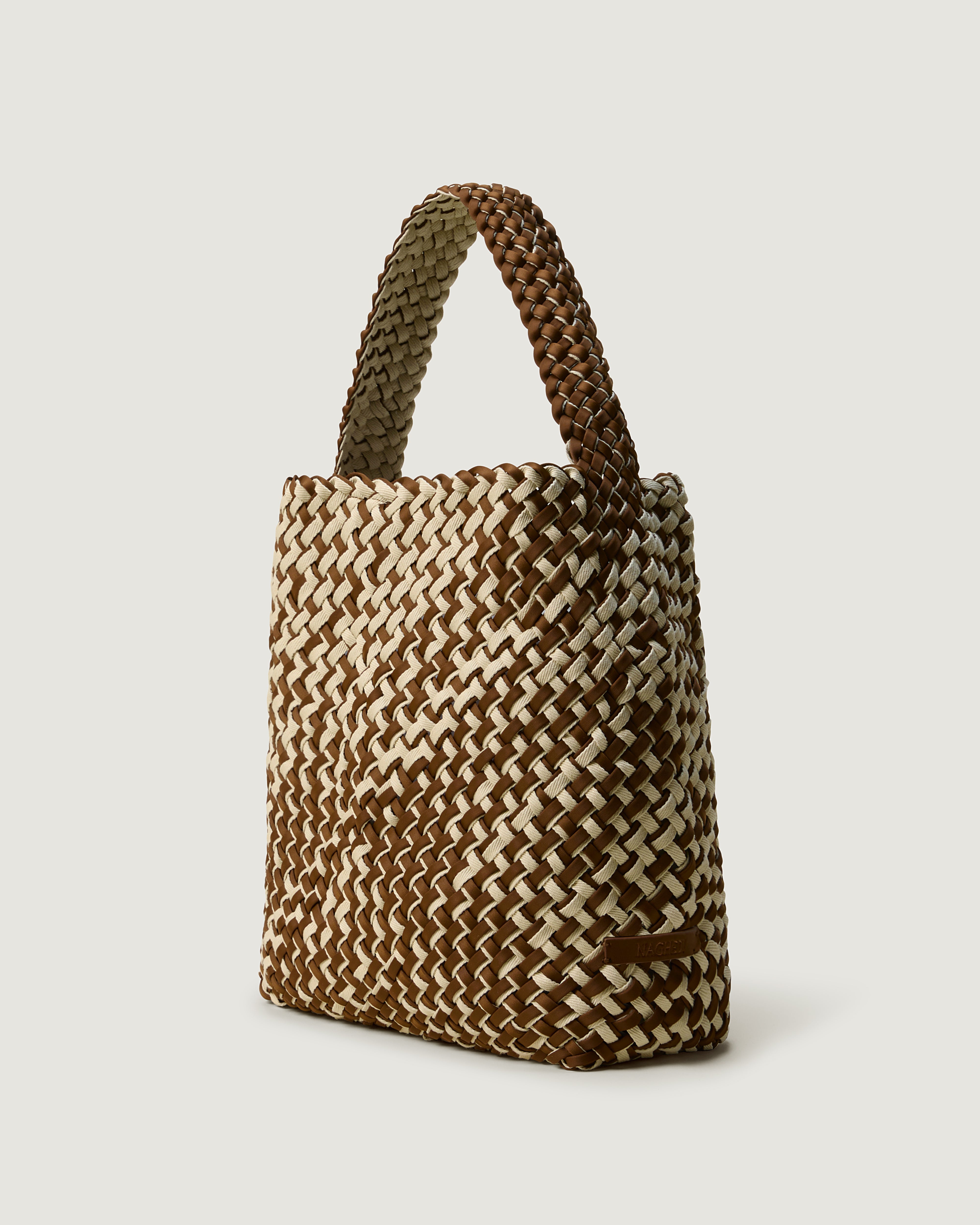 Nomad Hobo in Carmel shown from a side angle, highlighting its handwoven double weave construction and open top with magnetic snap closure.