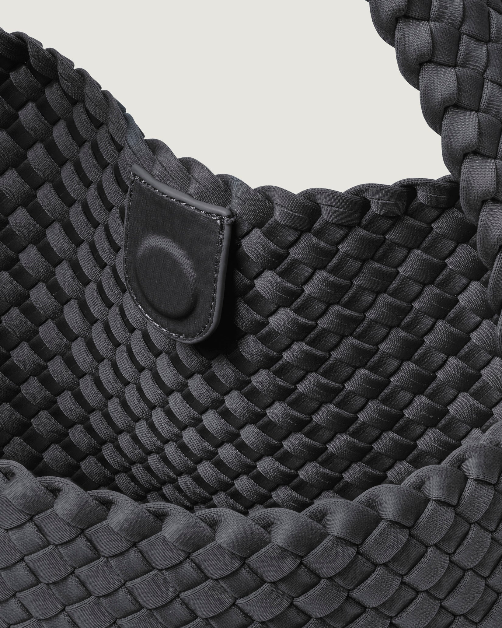 Interior close-up of Nomad Medium Hobo Bag in Ash showing its open top with magnetic snap closure, and unlined interior.