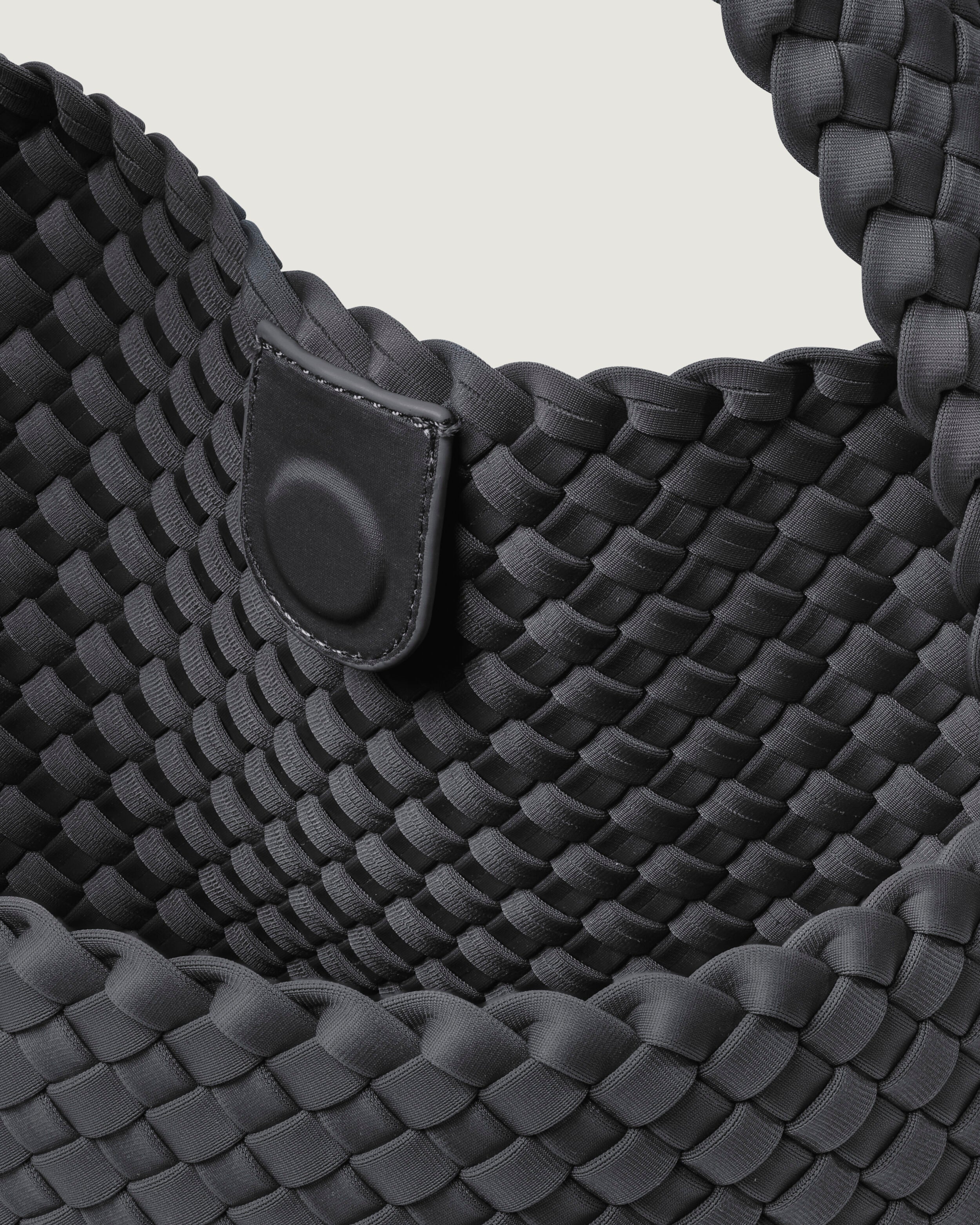 Interior close-up of Nomad Hobo in Ash showing its open top with magnetic snap closure, and unlined interior.