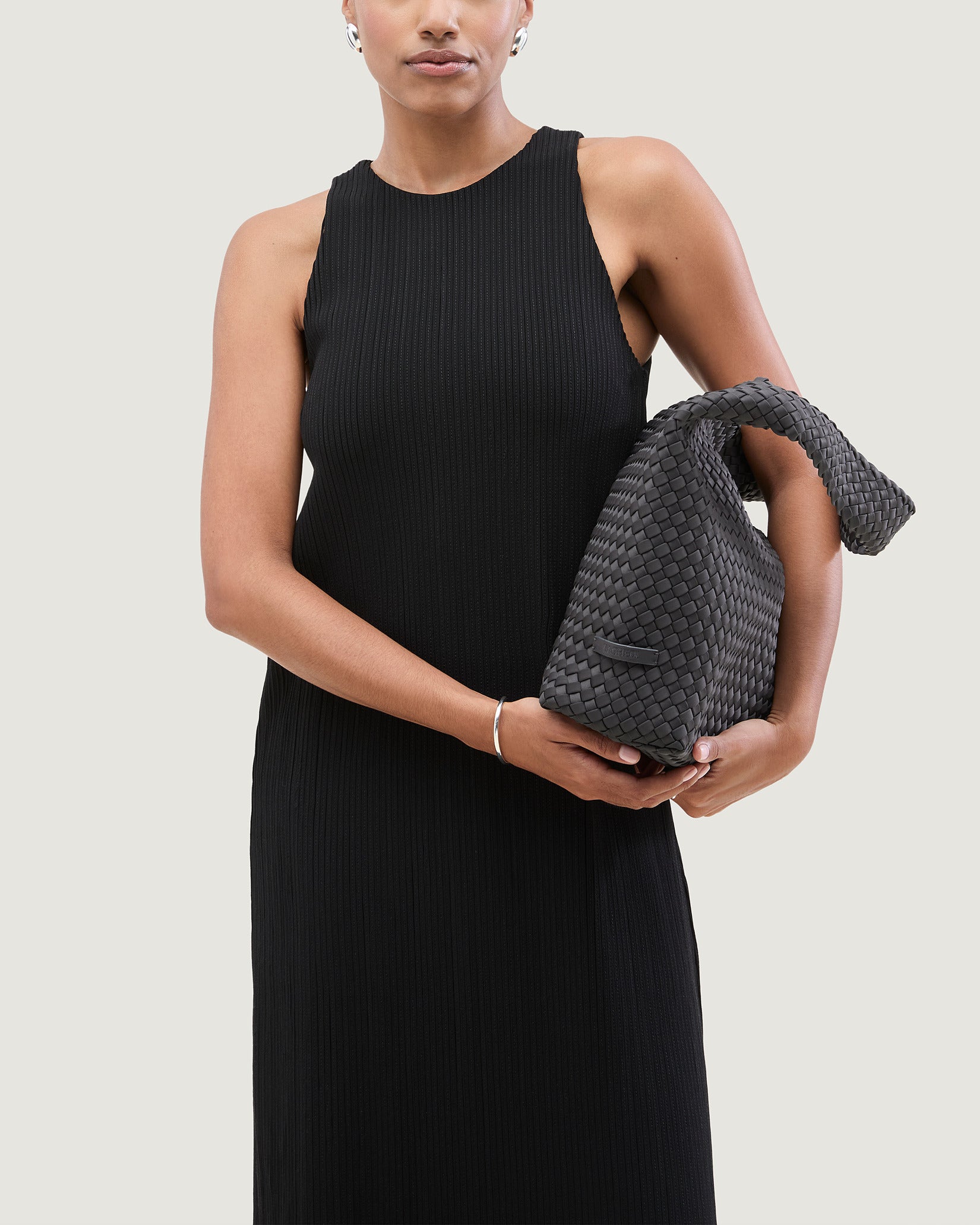 Nomad Medium Hobo Bag in Ash shown on model to illustrate scale and soft silhouette.