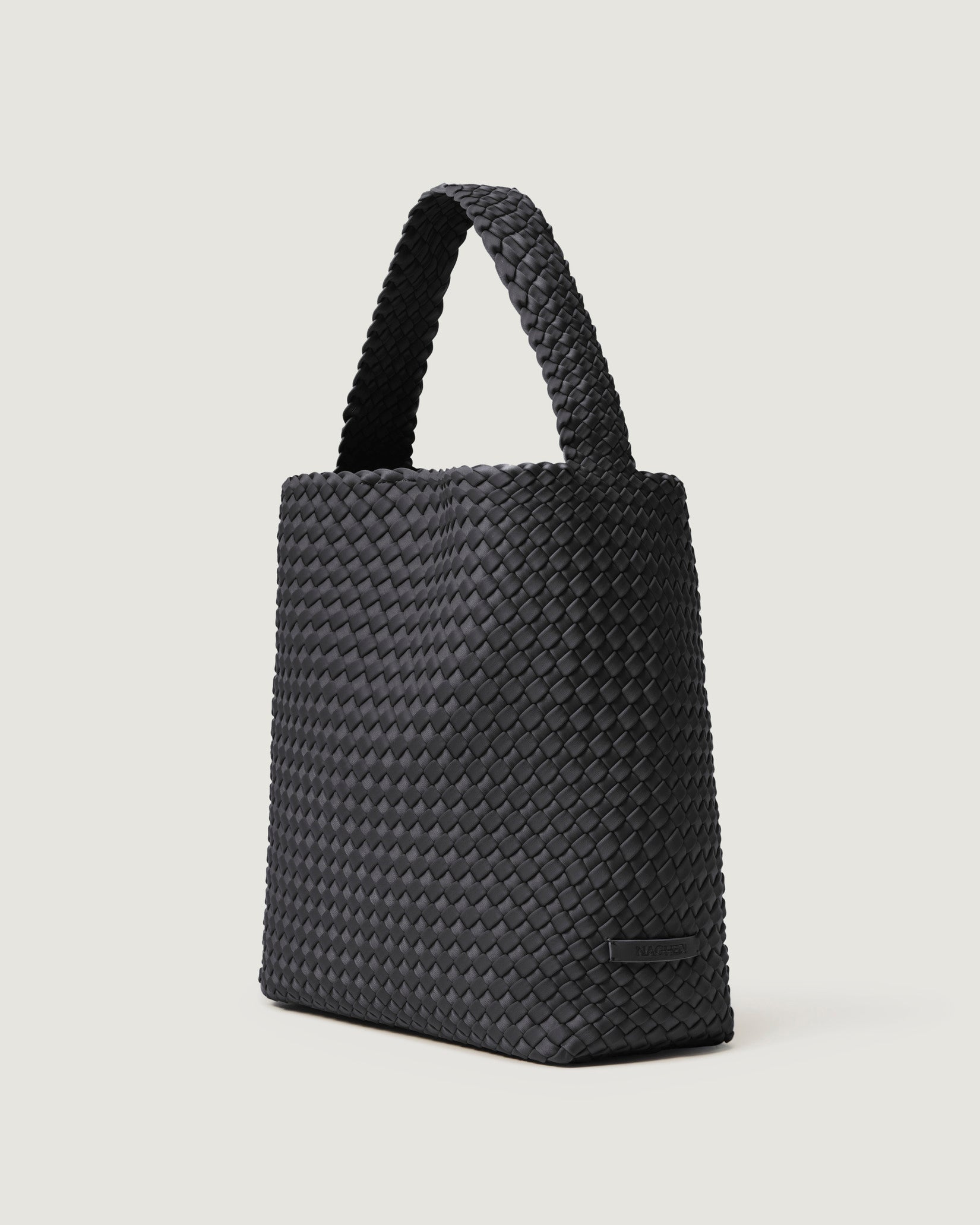 Nomad Medium Hobo Bag in Ash shown from a side angle, highlighting its handwoven neoprene and open top with magnetic snap closure.