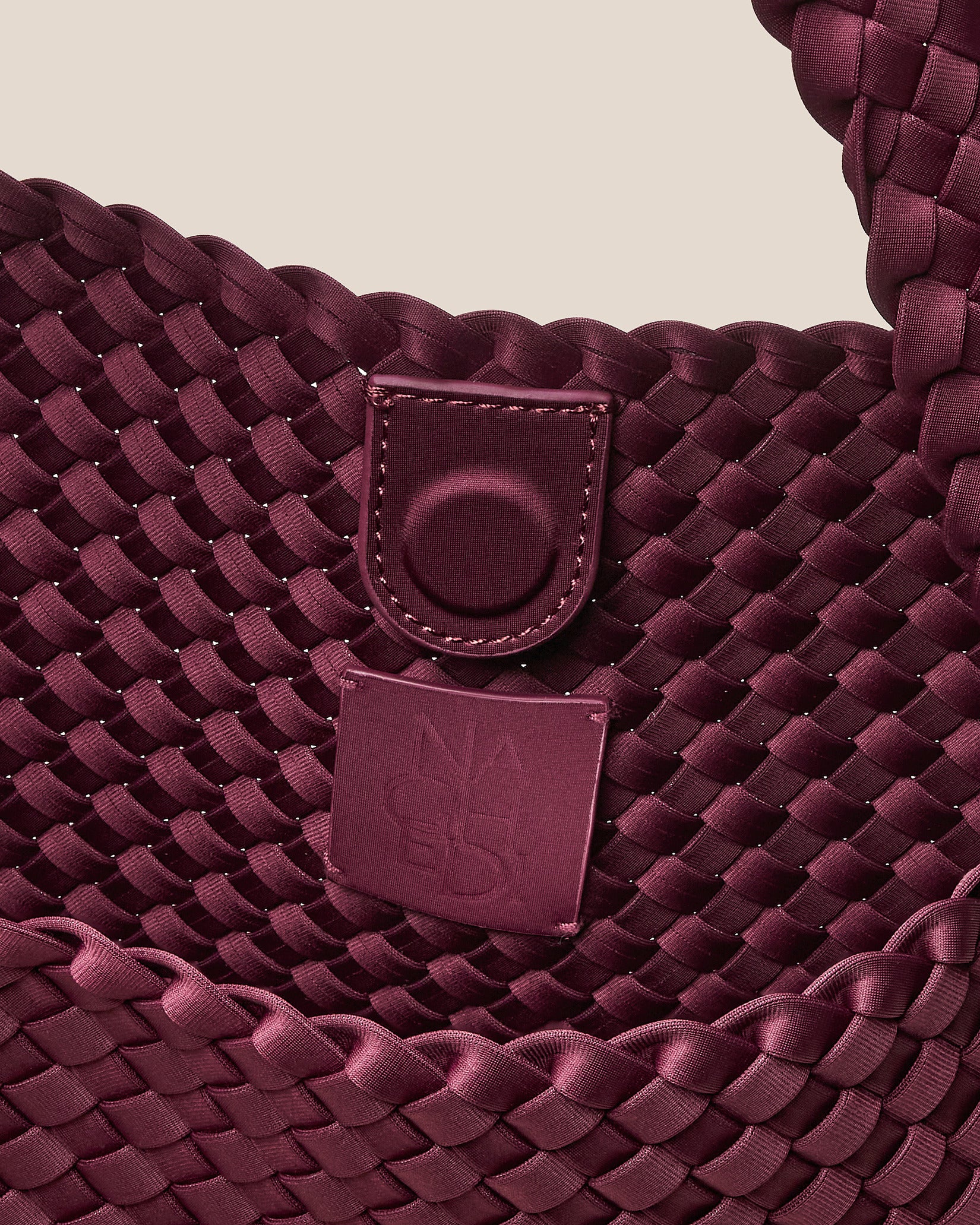 Interior close-up of Nomad Medium Hobo Bag in Bordeaux showing its open top with magnetic snap closure, and unlined interior.