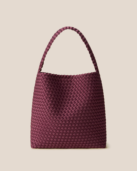 Nomad Medium Hobo Bag in Bordeaux, a rich burgundy tone, in handwoven neoprene featuring an open top with magnetic snap closure, and handwoven shoulder strap lays comfortably flat.