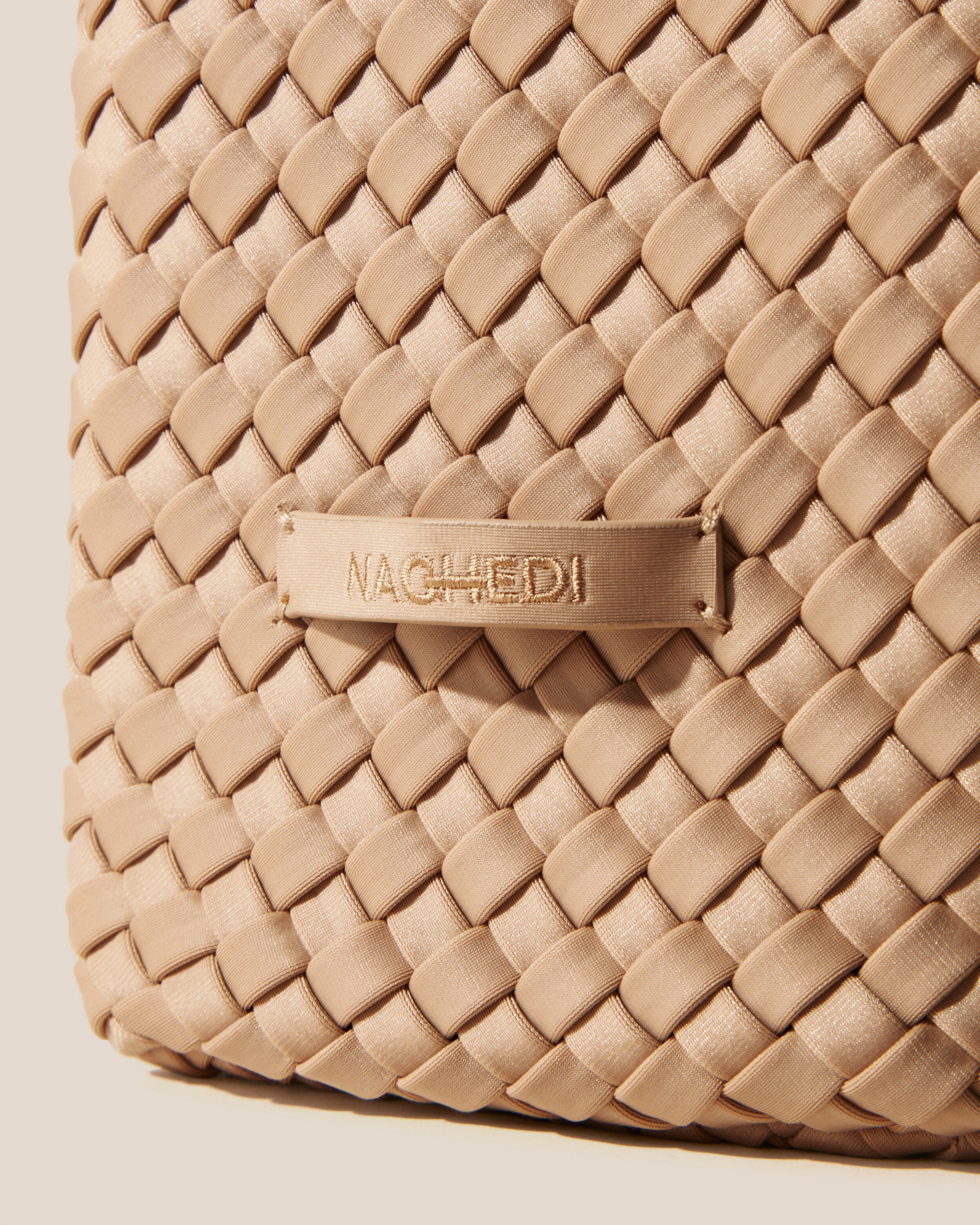 Close-up of stamped NAGHEDI logo on Nomad Hobo in Camel.