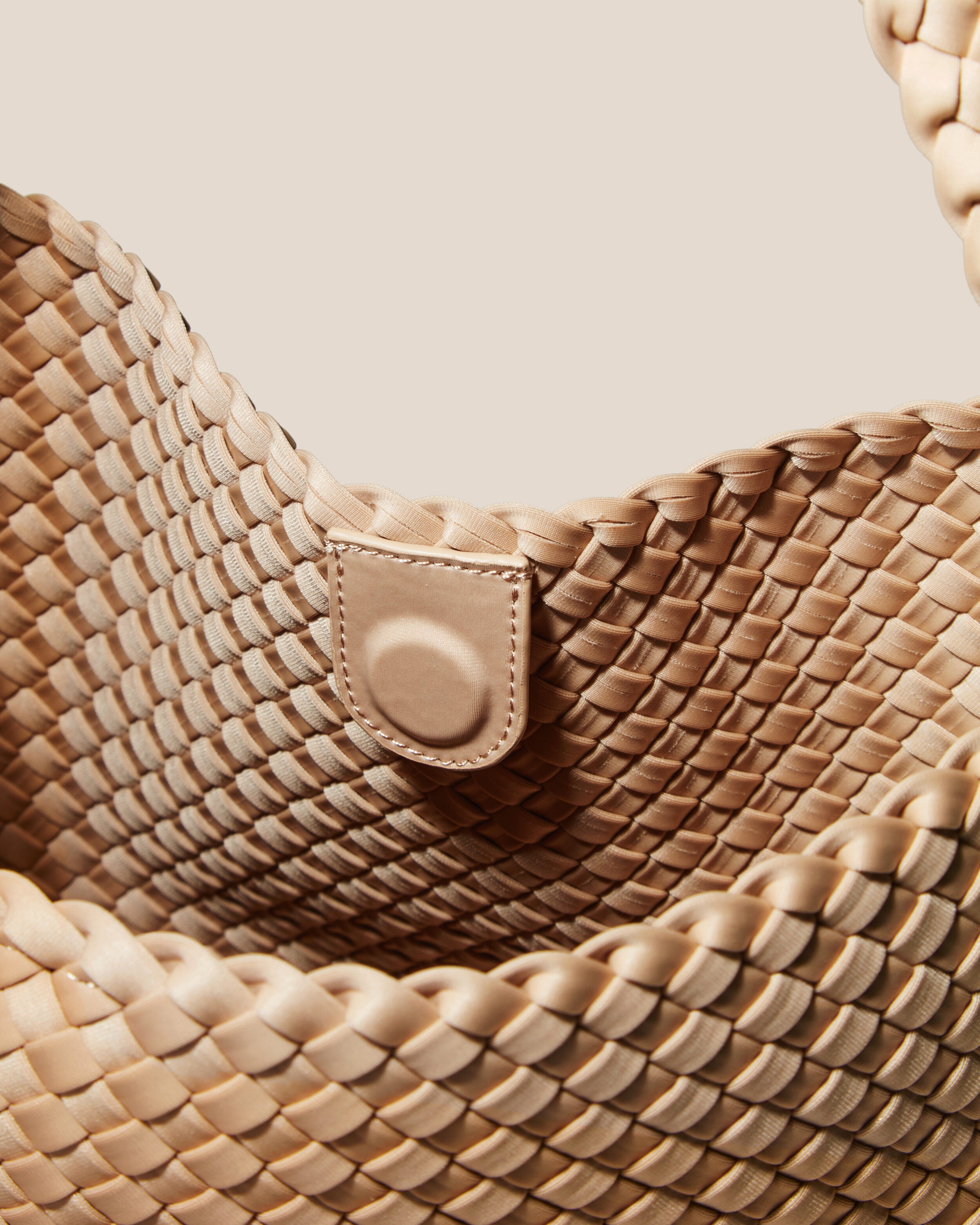 Interior close-up of Nomad Hobo in Camel showing its open top with magnetic snap closure, and unlined interior.