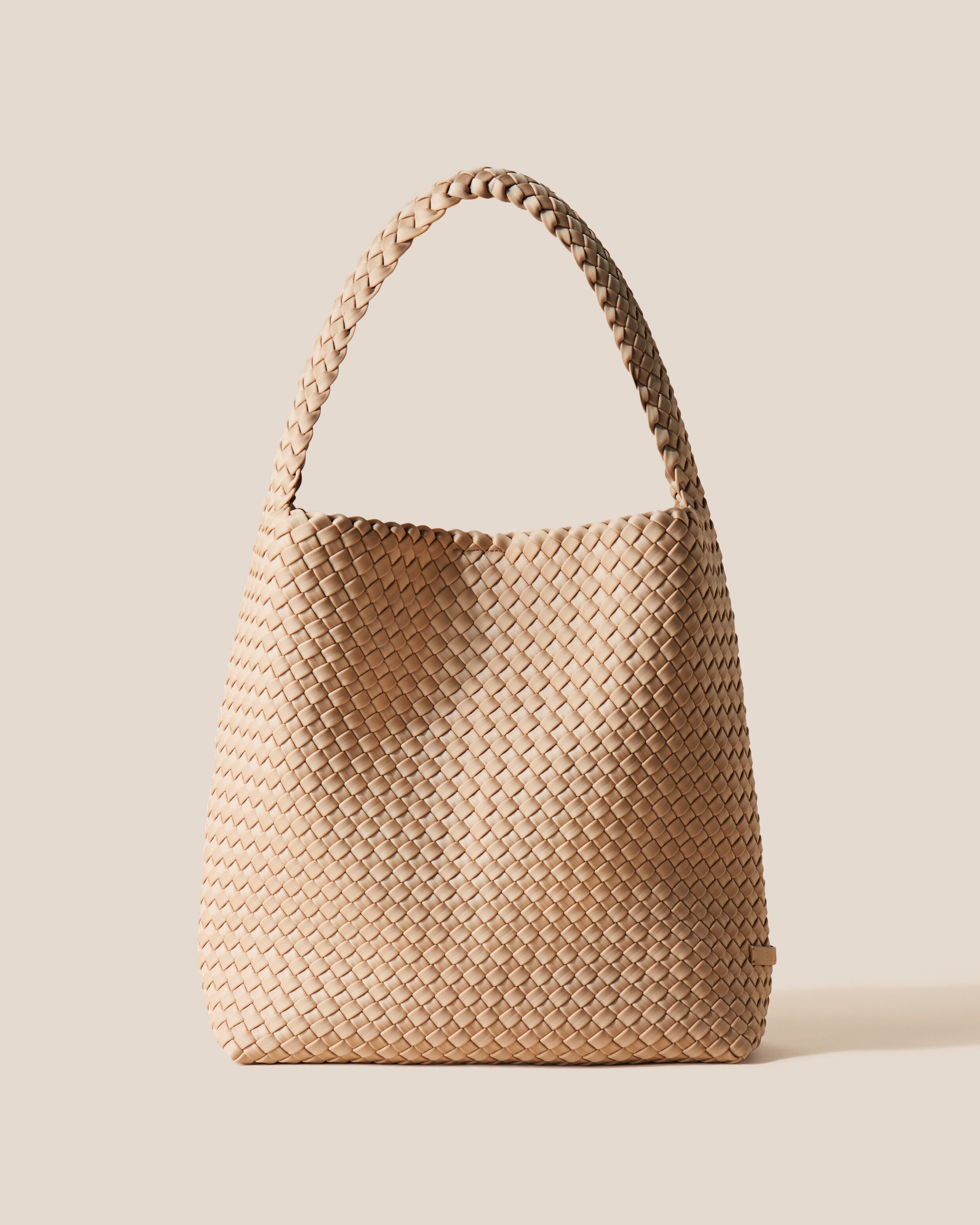 Nomad Hobo in Camel, a camel brown tone, in handwoven neoprene, featuring an open top with magnetic snap closure, and handwoven shoulder strap lays comfortably flat.