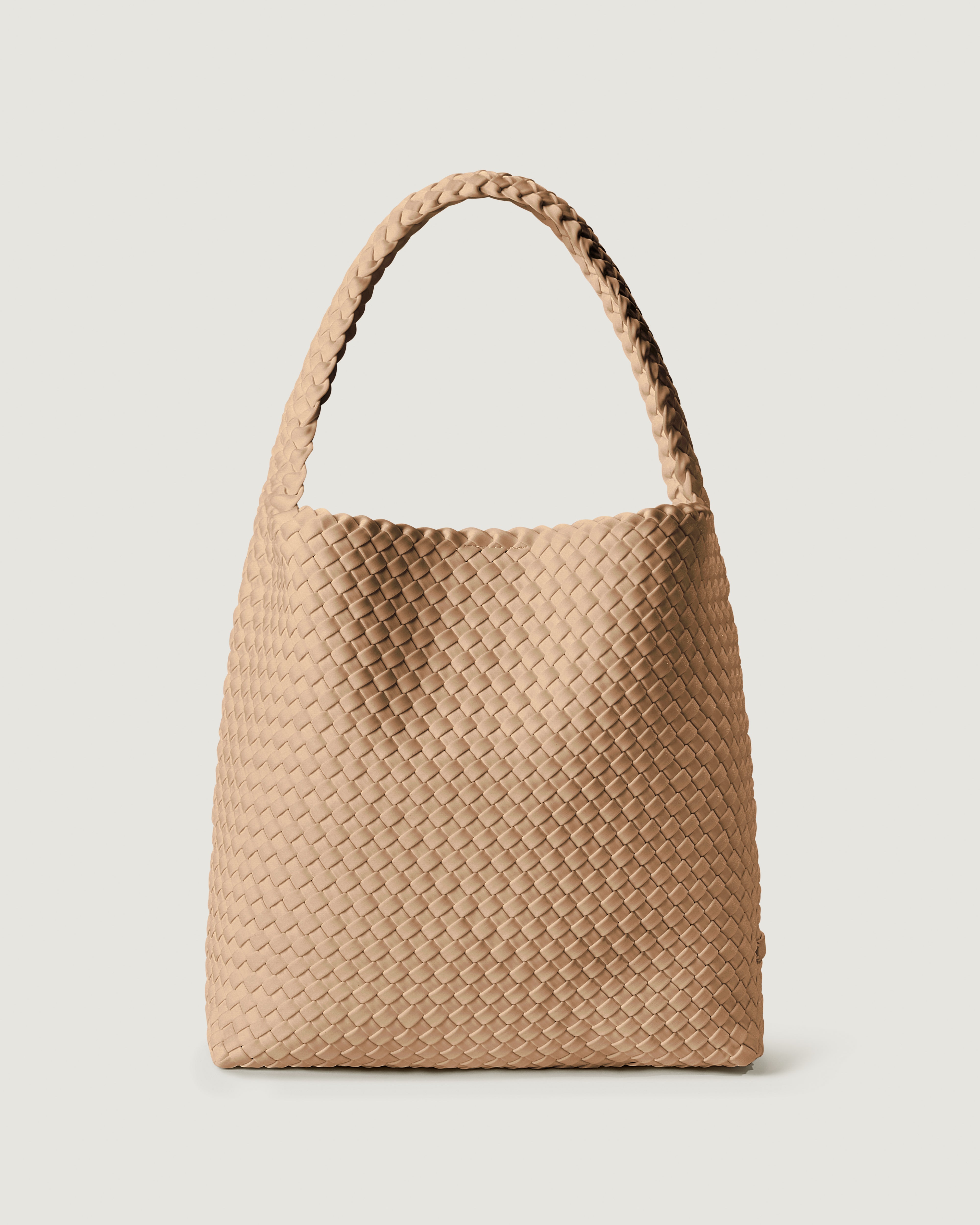 Nomad Hobo in Camel, a camel brown tone, in handwoven neoprene, featuring an open top with magnetic snap closure, and handwoven shoulder strap lays comfortably flat.