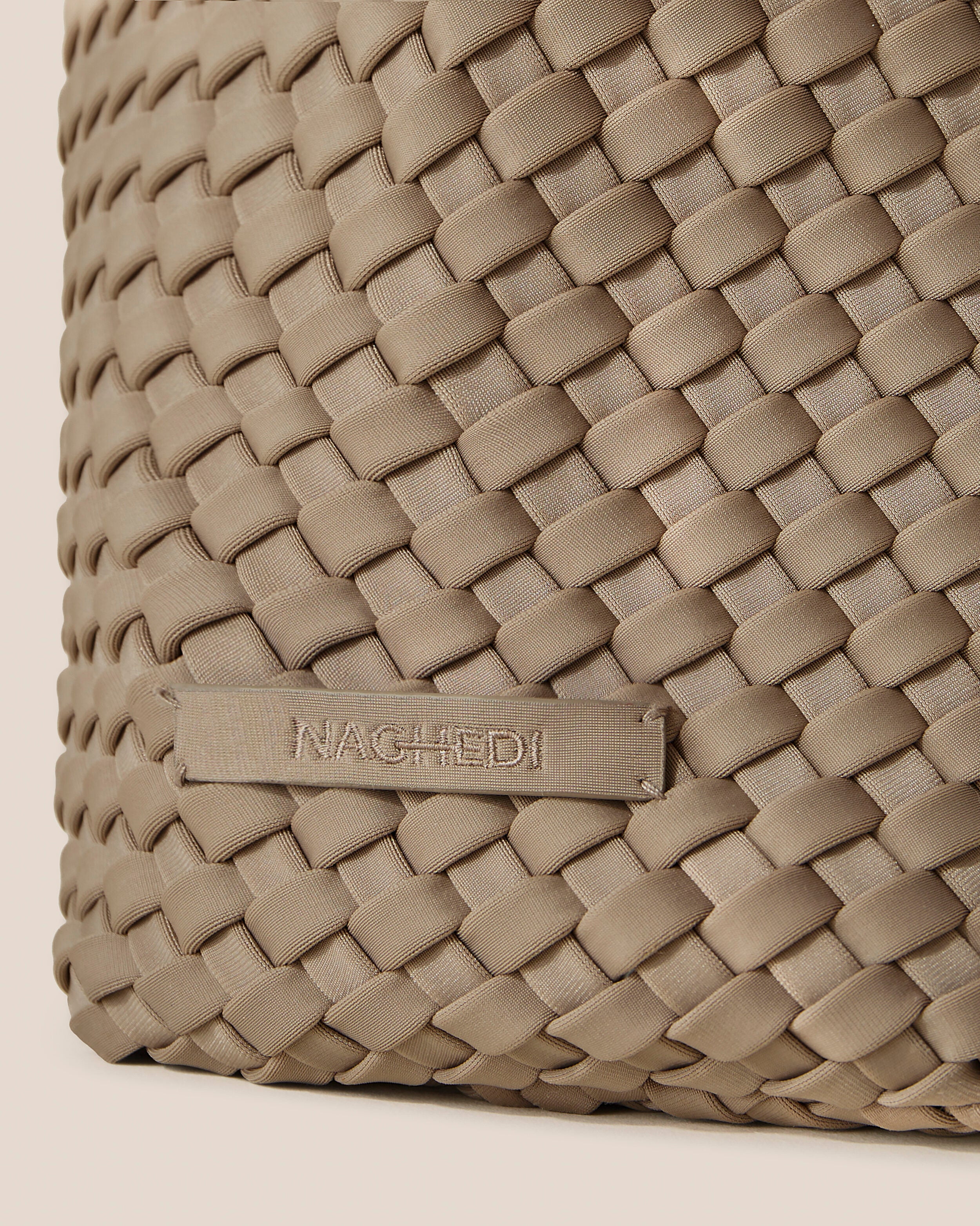 Close-up of stamped NAGHEDI logo on Nomad Hobo in Cashmere.